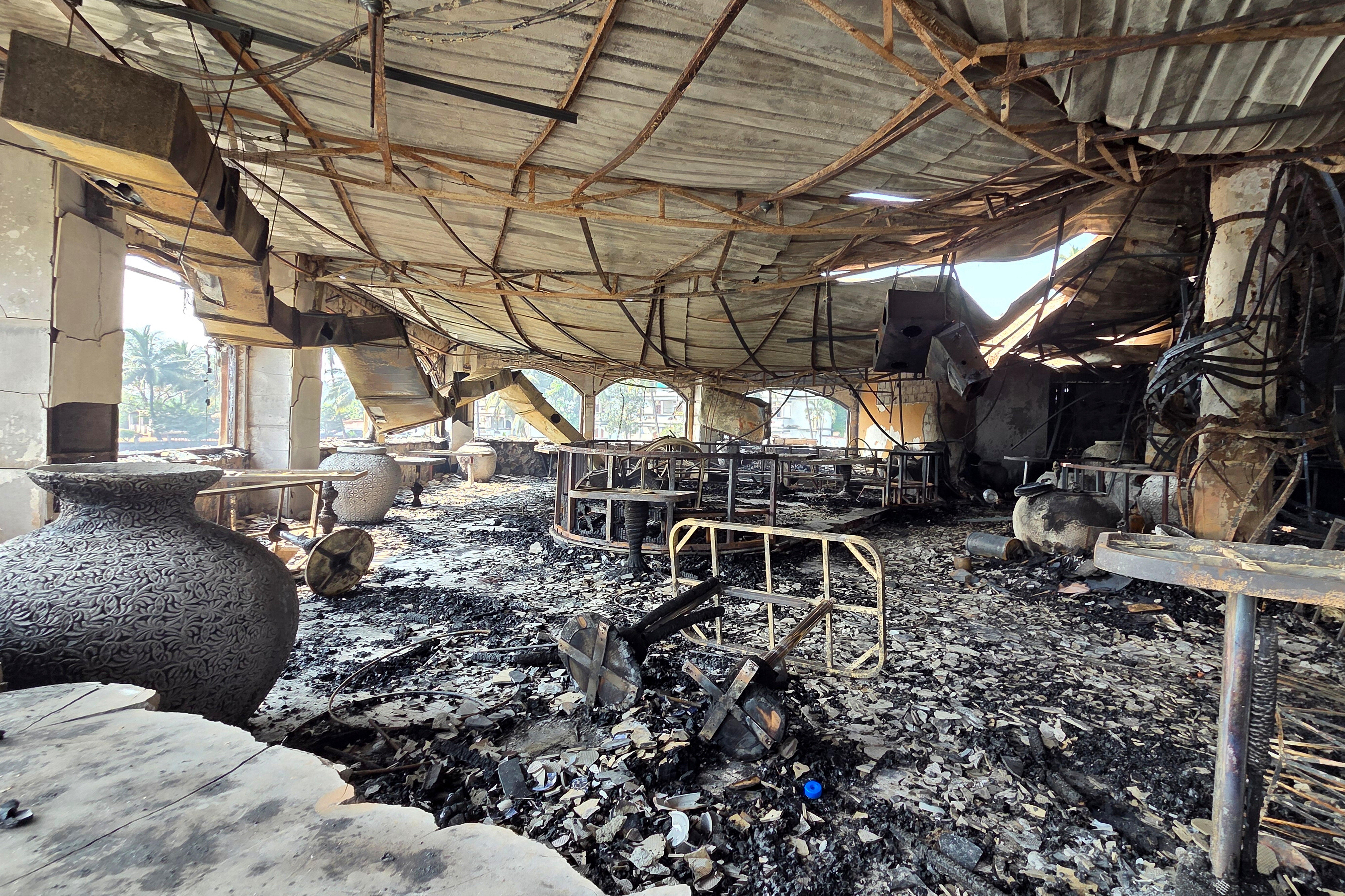 The charred interiors of a nightclub, which caught fire early Sunday, are seen in Arpora, Goa