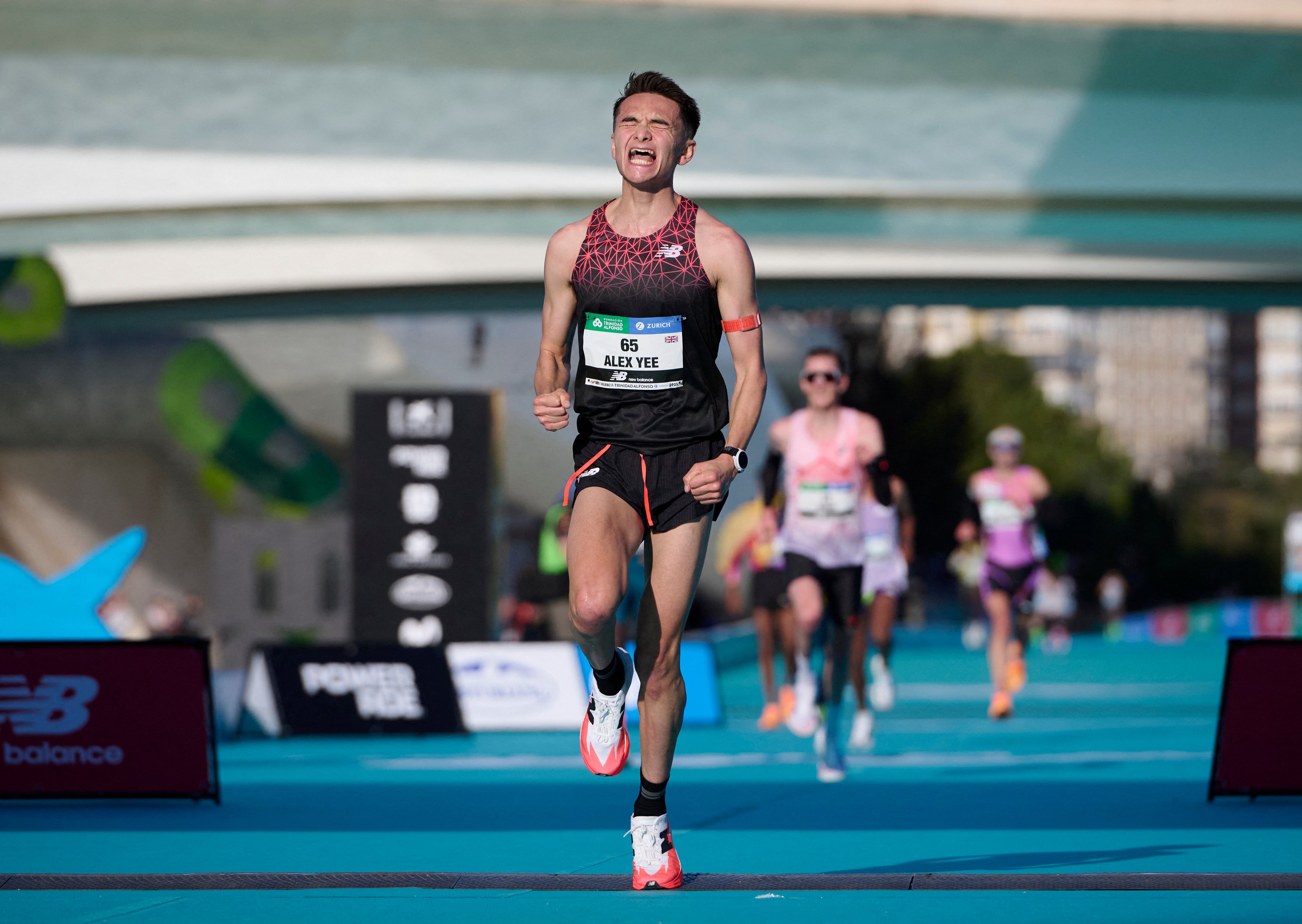 <p>Britian’s Alex Yee reacts after finishing in seventh place in the Valencia marathon</p>