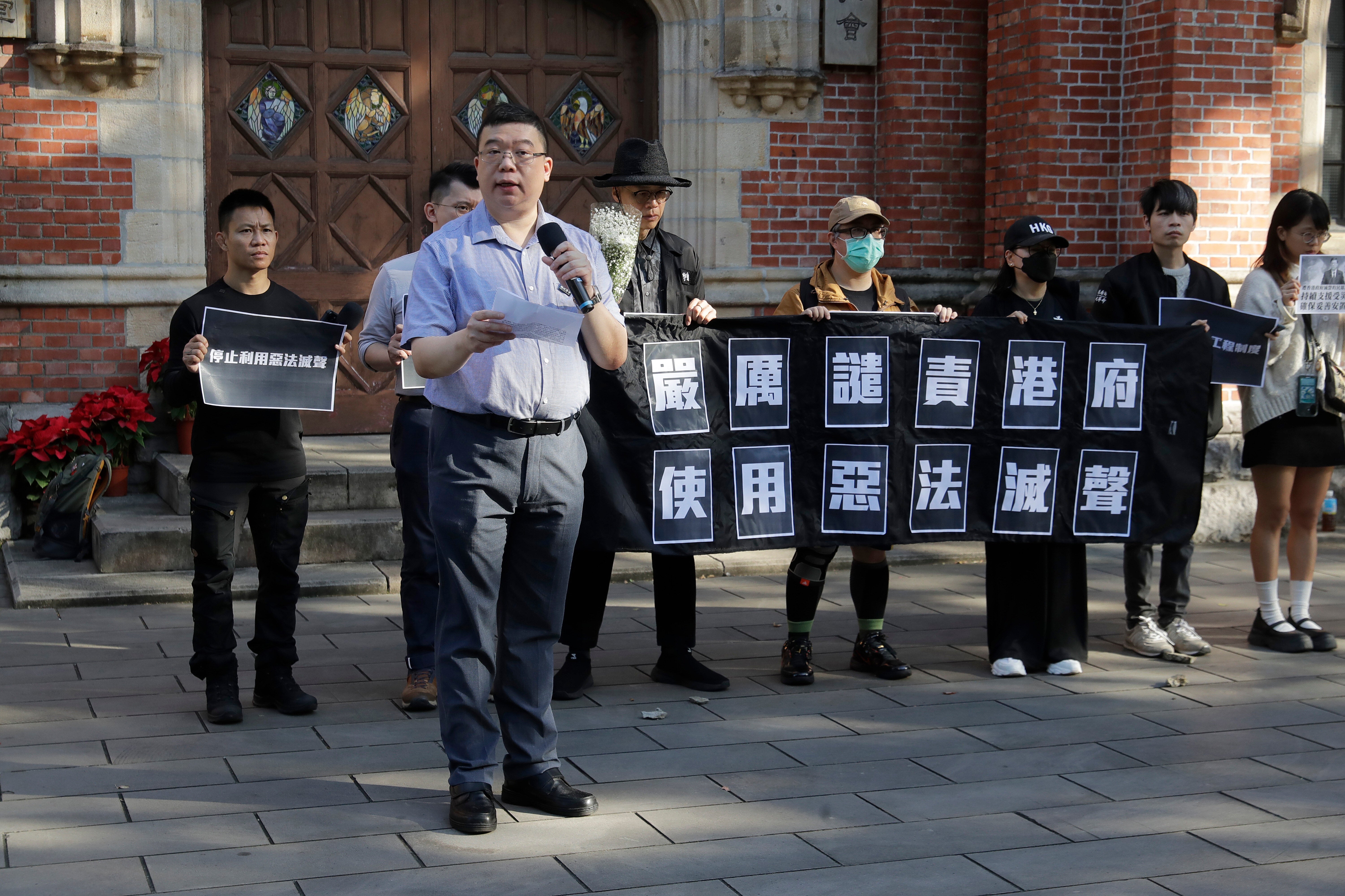 A Hong Kong activist delivers a speech during a press event for the victims of the Wang Fuk Court fire in Hong Kong, in Taipei, Taiwan