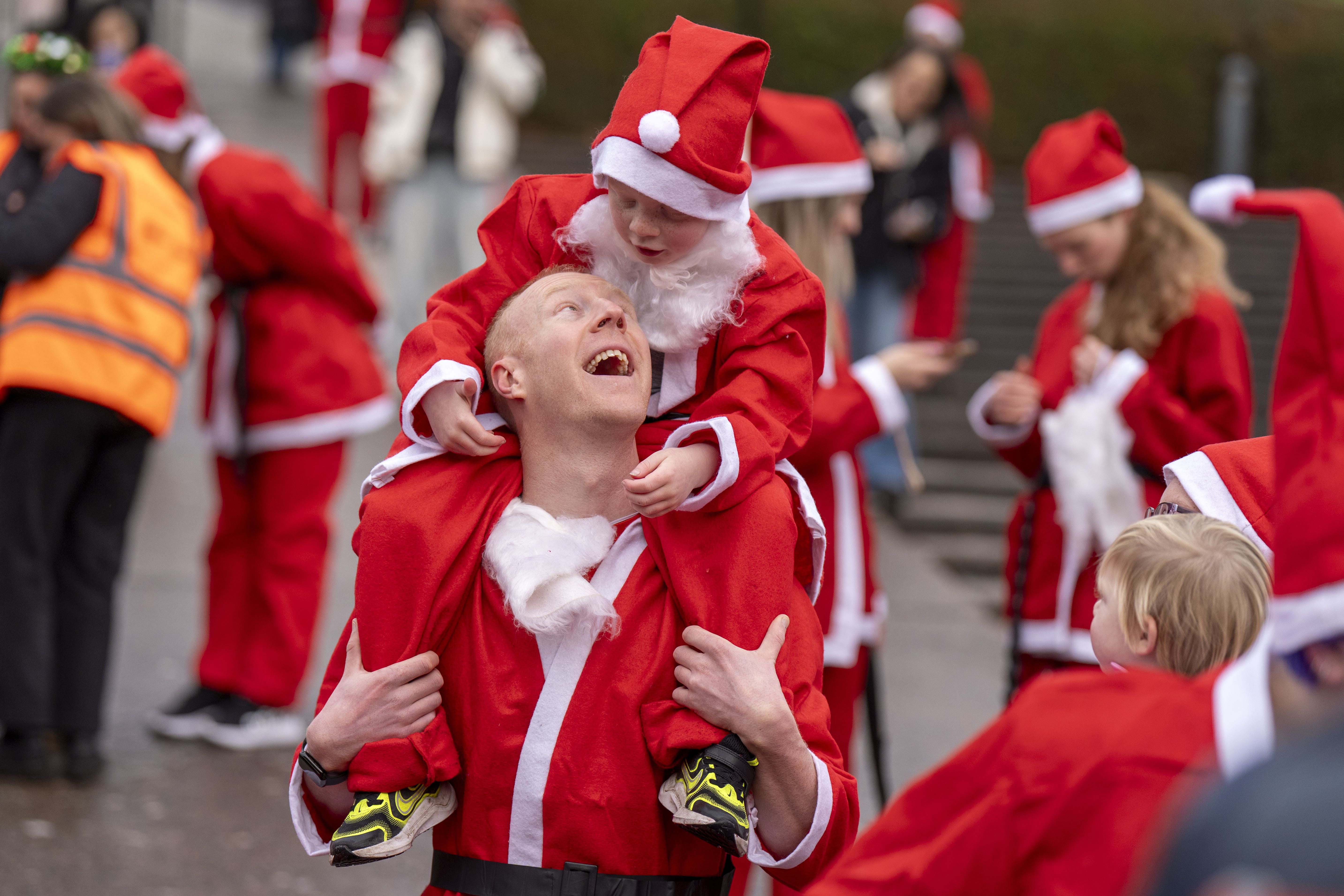 Hundreds of people take part in the annual festive Santa Dash through Princes Street Gardens in Edinburgh (Jane Barlow/PA)