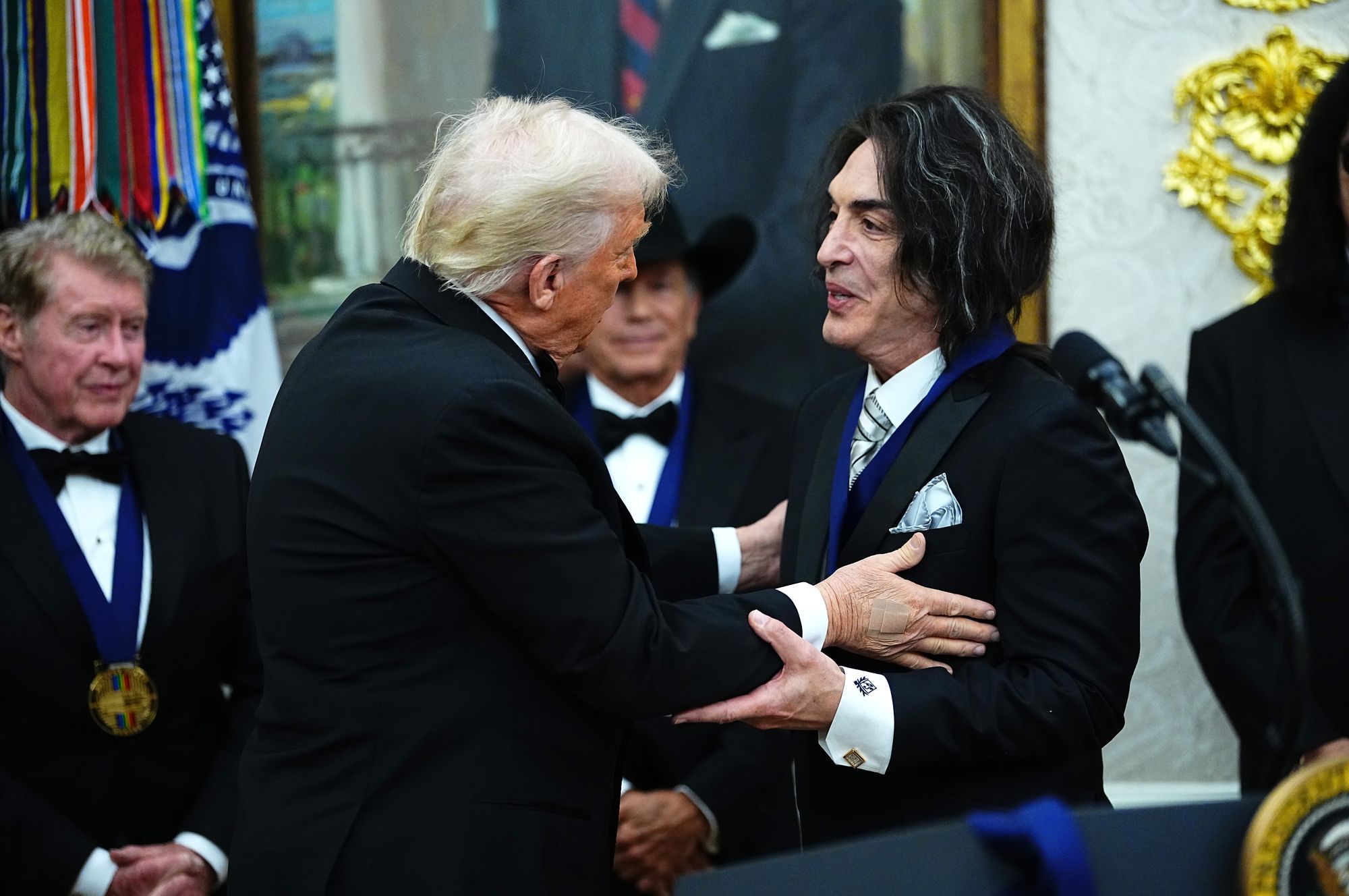 Trump embraces Paul Stanley of KISS after awarding him a medal for the 2025 Kennedy Center Honorees