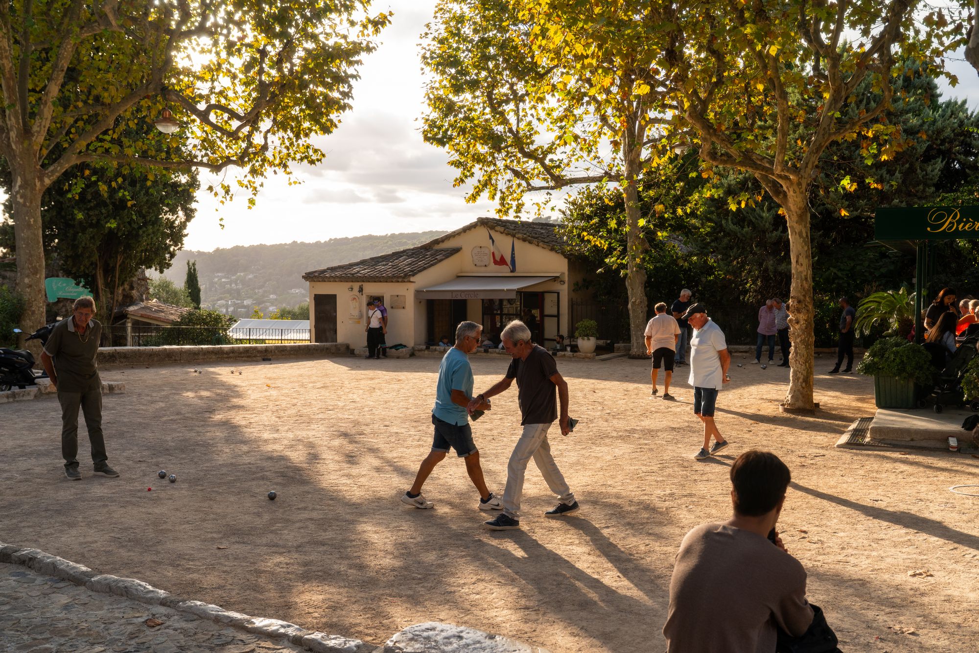 Locals played pétanque in a town courtyard