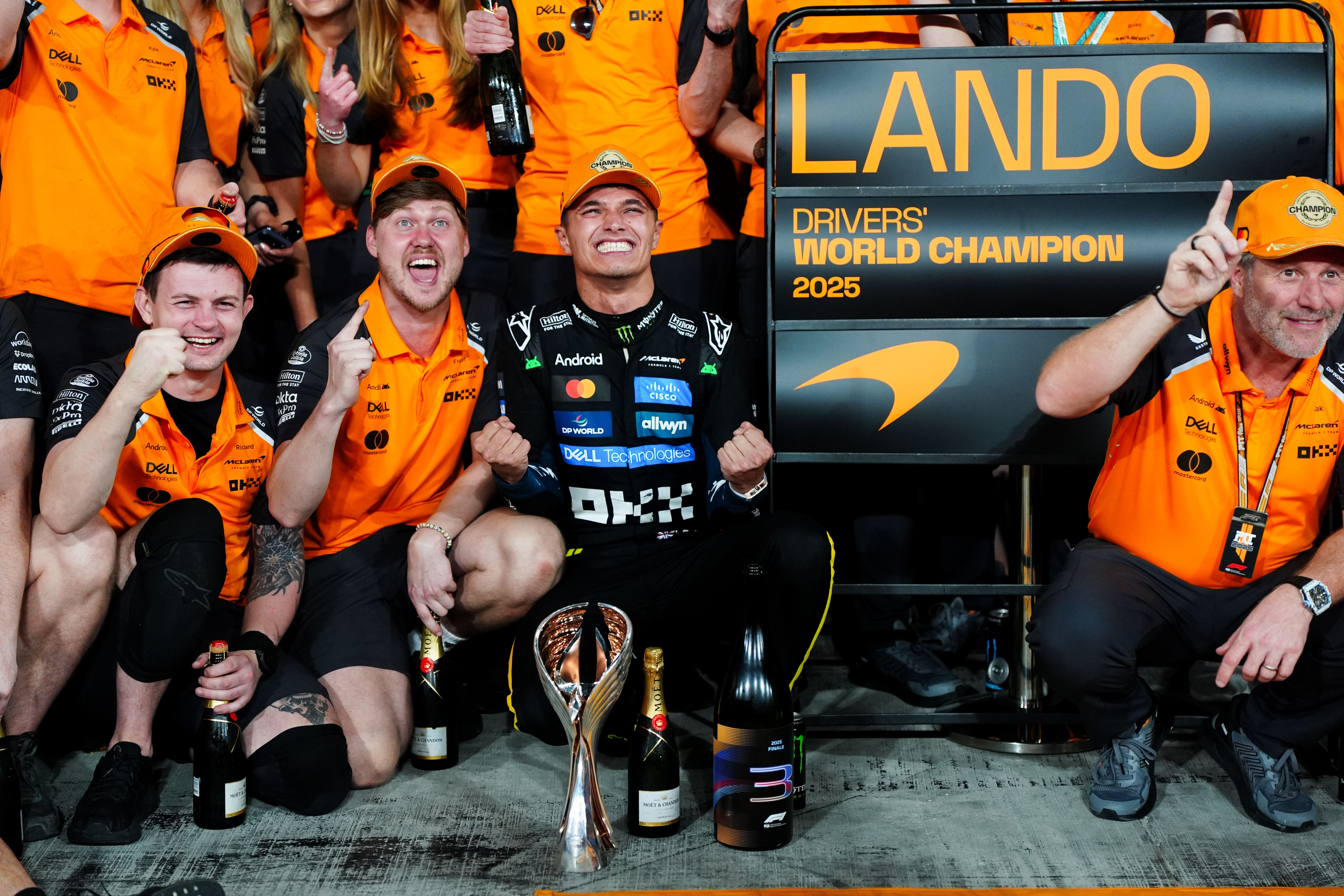 Lando Norris celebrates winning the world championship with McLaren staff (David Davies/PA)