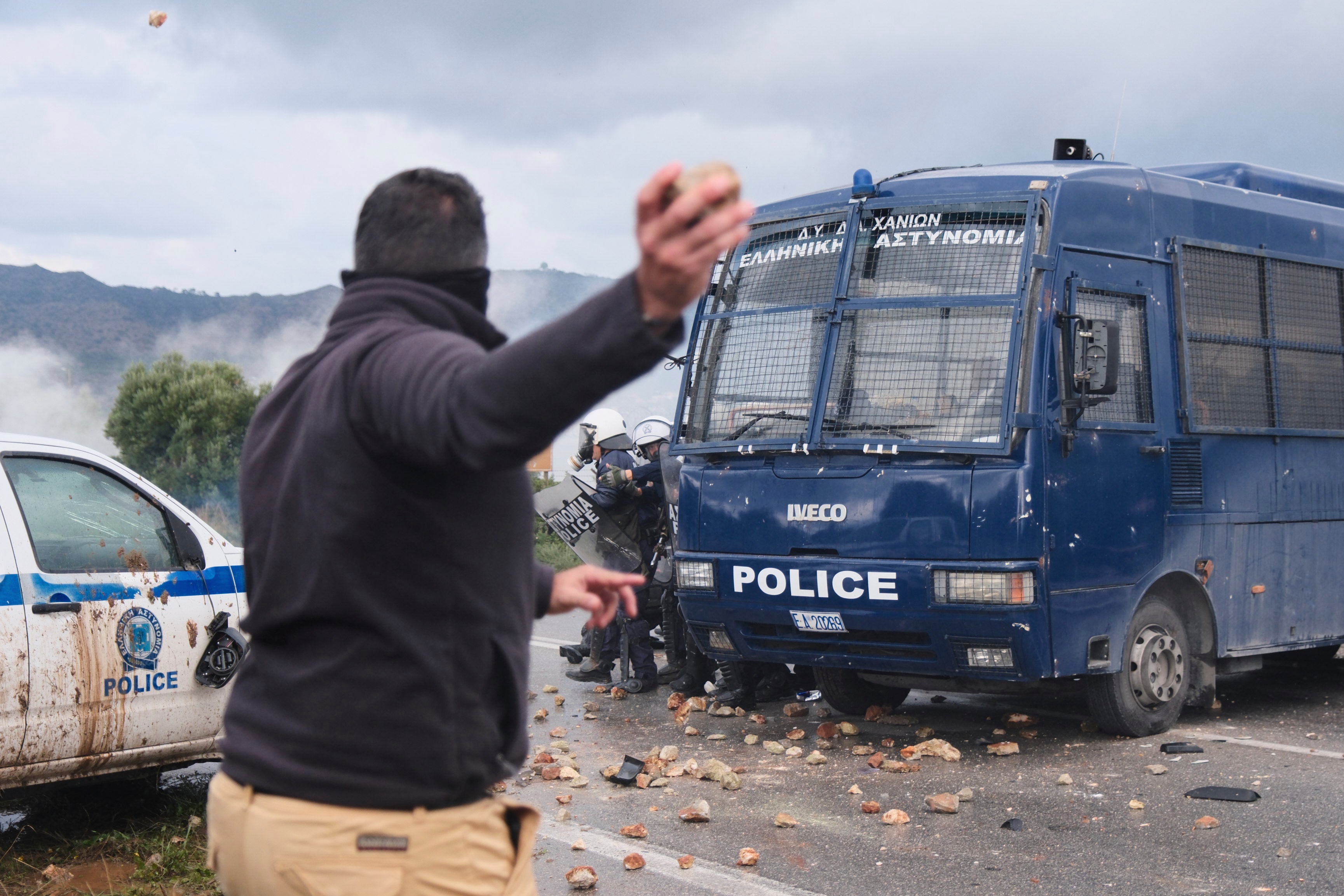 Farmers throw stones at police during clashes with officers blocking their march to Chania's airport on Crete