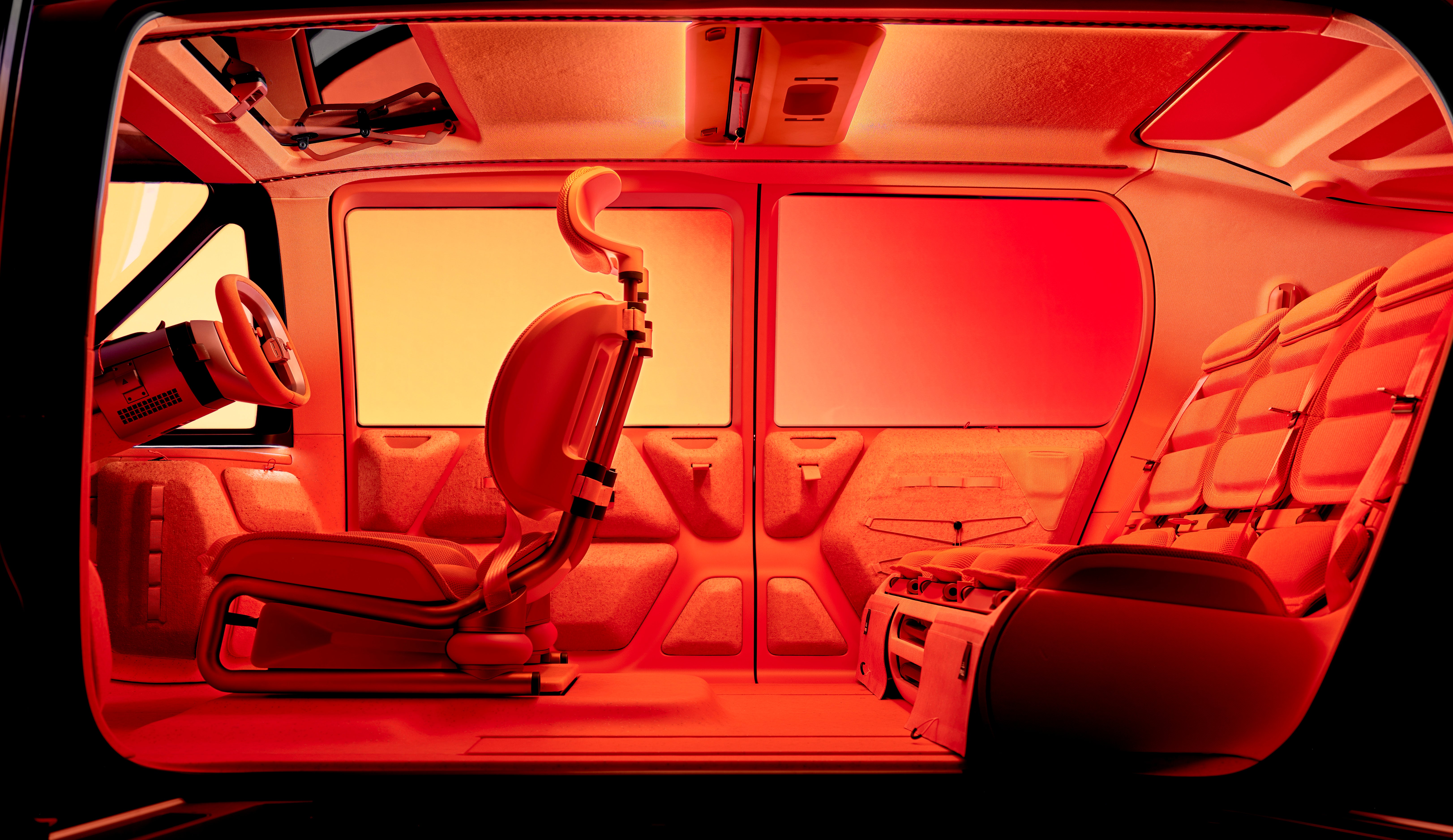 In a sea of orange the interior of the Citroen ELO Concept features a central driving seat