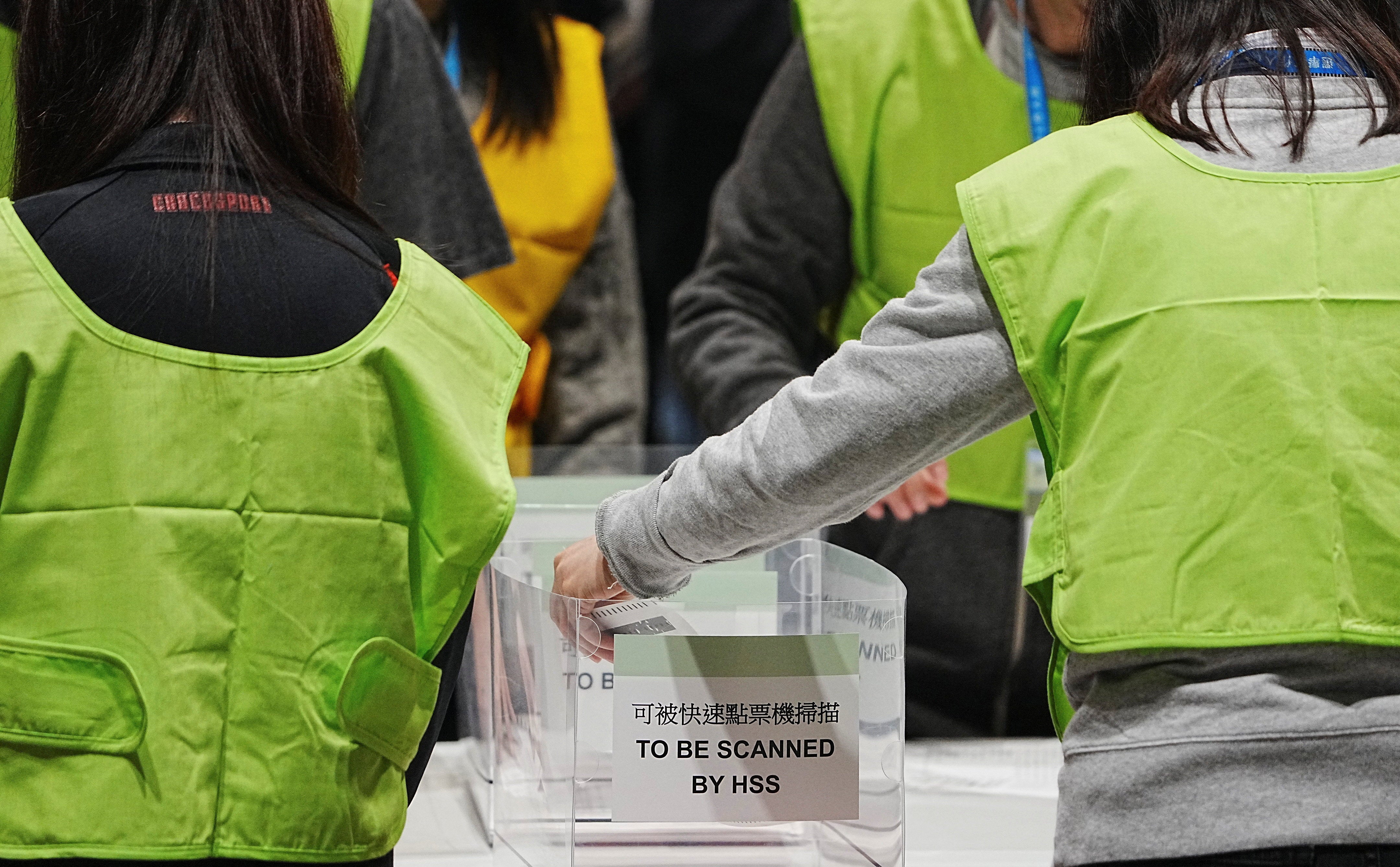 Electoral workers count votes for the legislative election at a vote counting centre in Hong Kong, China, 7 December 2025