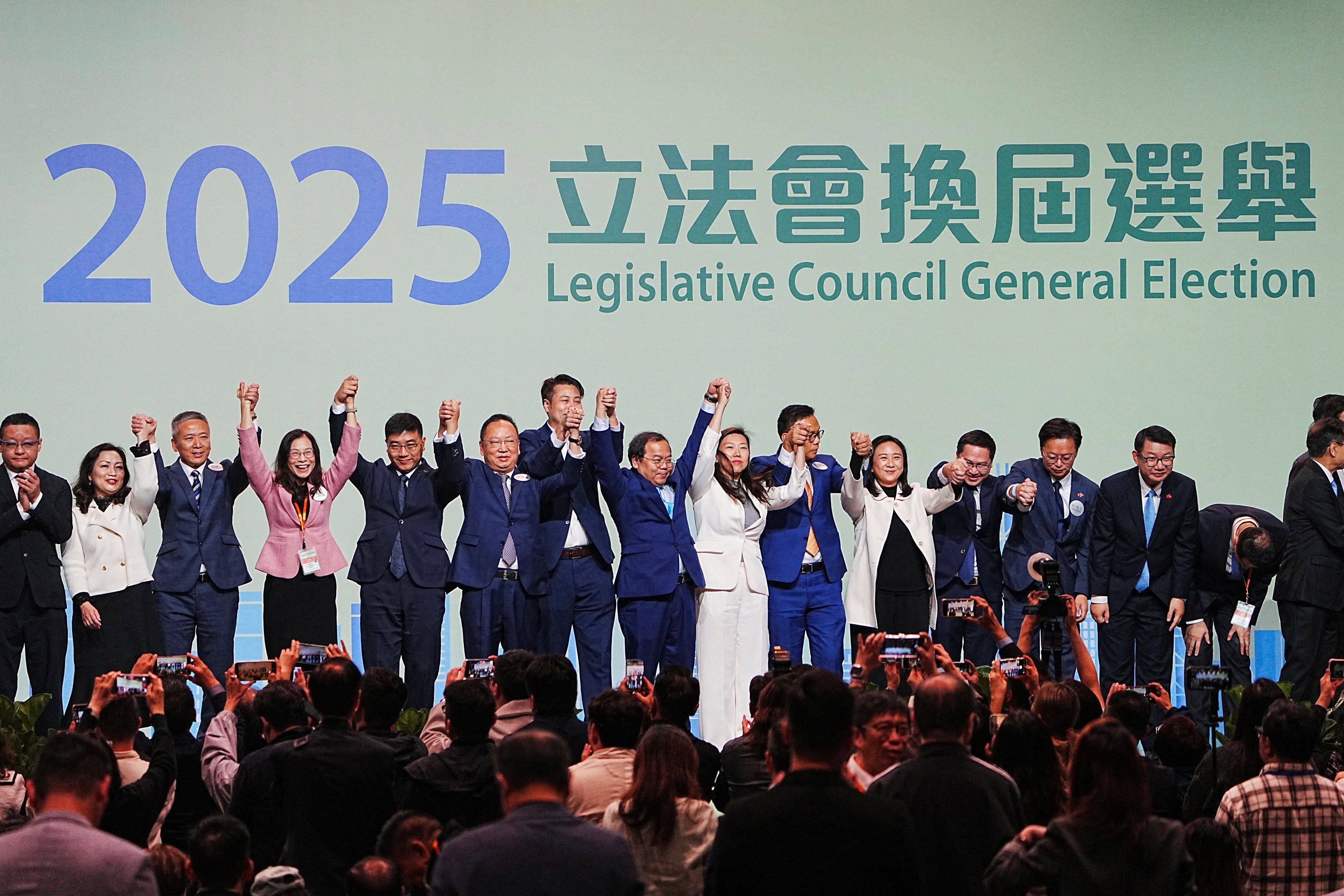 Candidates celebrate after winning in the legislative election in Hong Kong, China, 8 December 2025