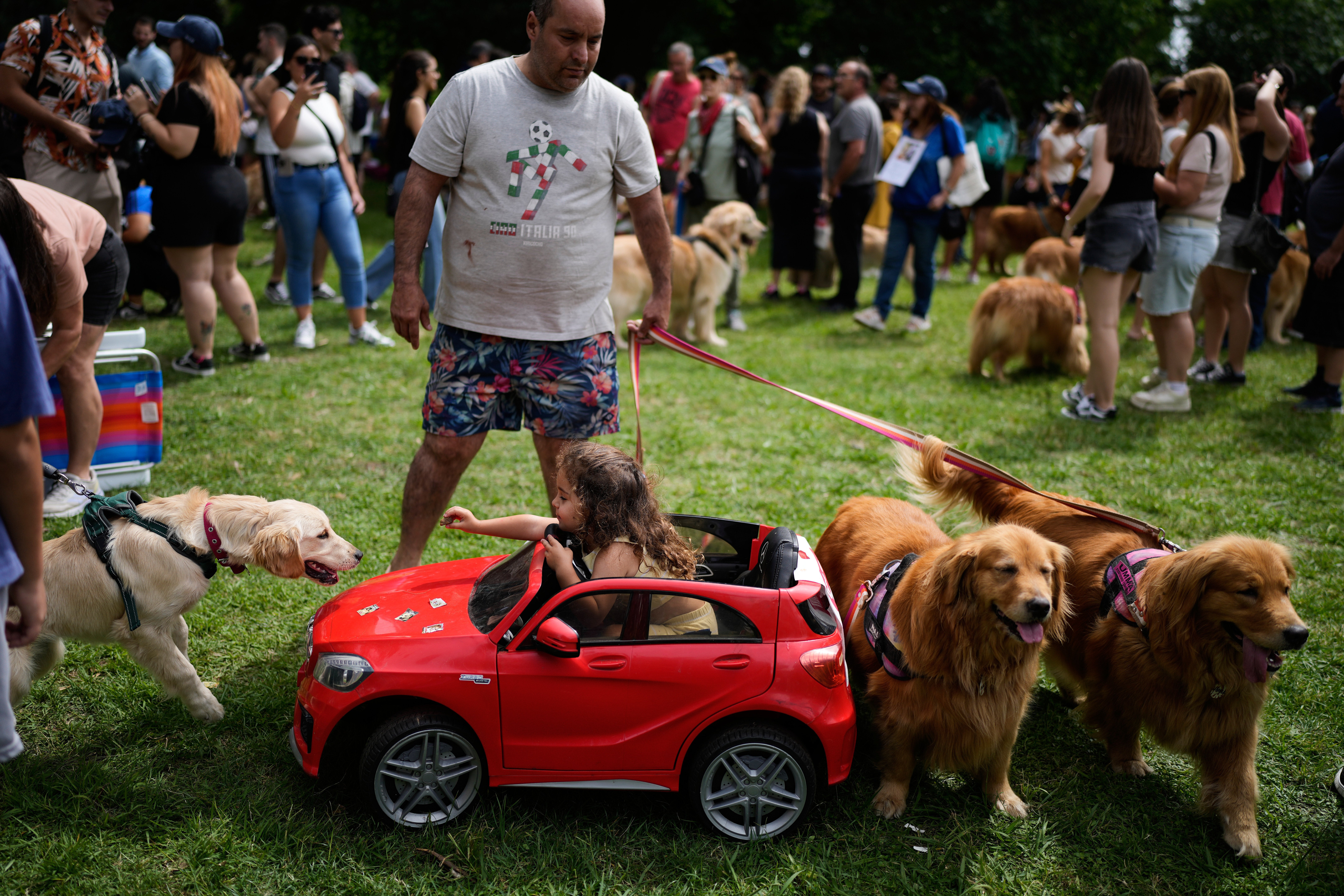 A young girl offers a treat to one of the 2,300 dogs gathered for the unofficial world record attempt