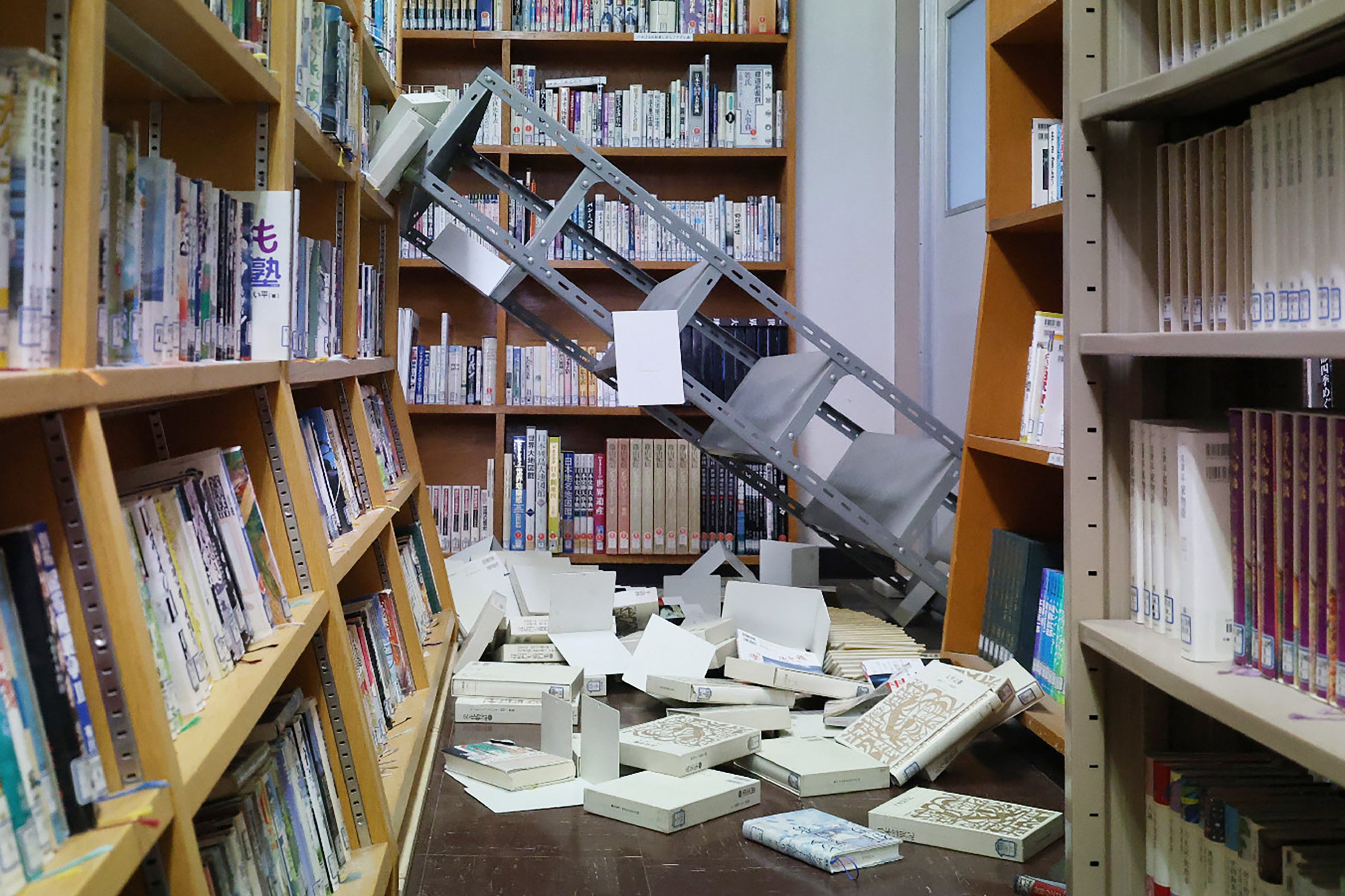 Collapsed bookshelves at a high school library are seen in Hachinohe City in Aomori Prefecture on 9 December 2025, following a 7.5 magnitude earthquake off northern Japan