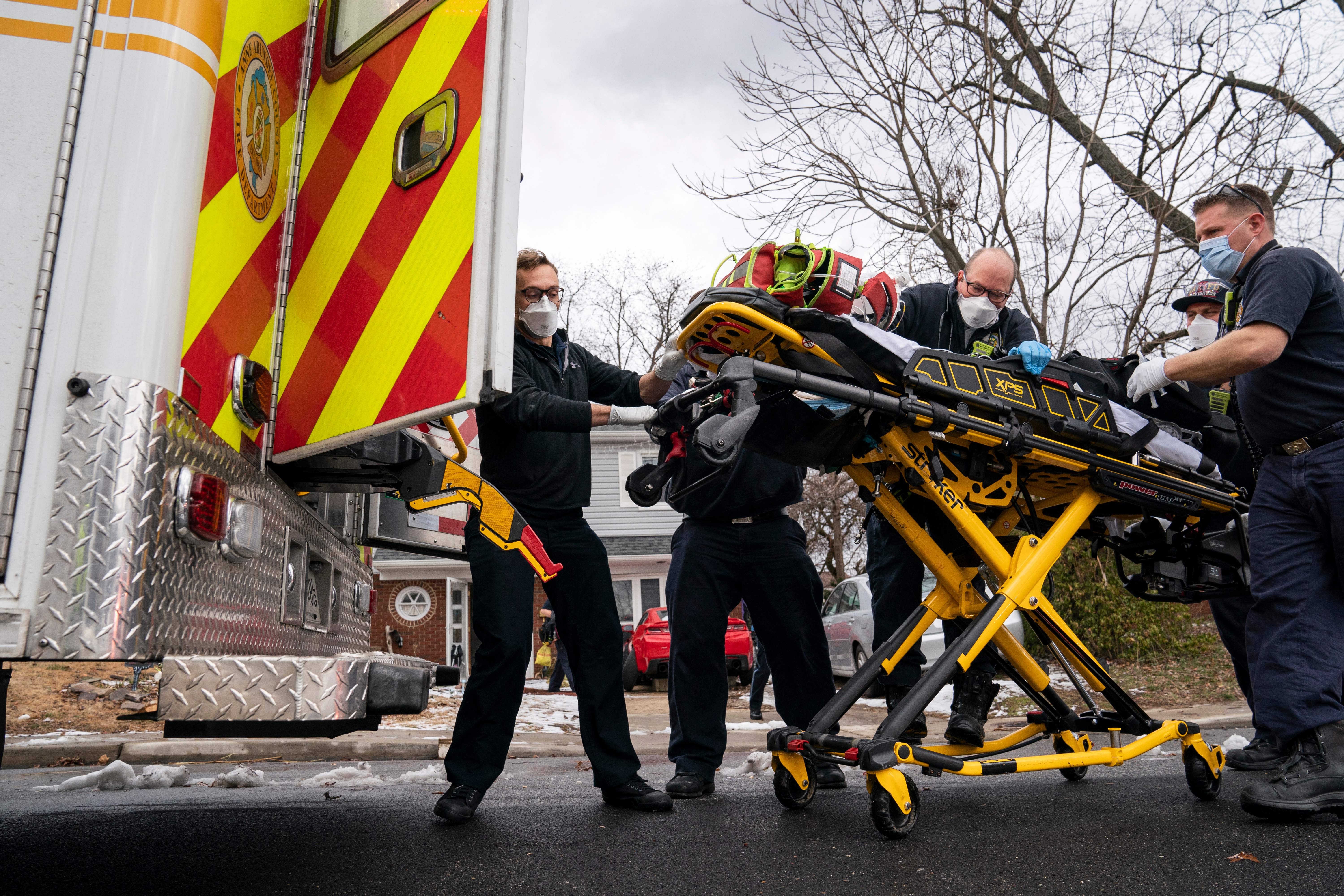 Firefighters and paramedics with Anne Arundel County Fire Department load a patient into an ambulance in Glen Burnie, Maryland, in January 2022. Some patients in rural communities have to travel distances over 40 miles for care