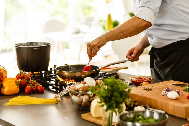 <p>Man cooking in the kitchen, preparing pasta, cooking spaghetti</p>