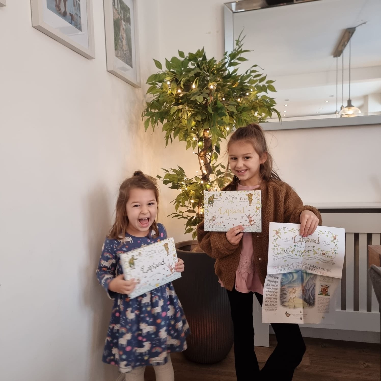 Sienna (left) and her sister Adriana receiving their Lapland invitation, just days before she would be taken to hospital