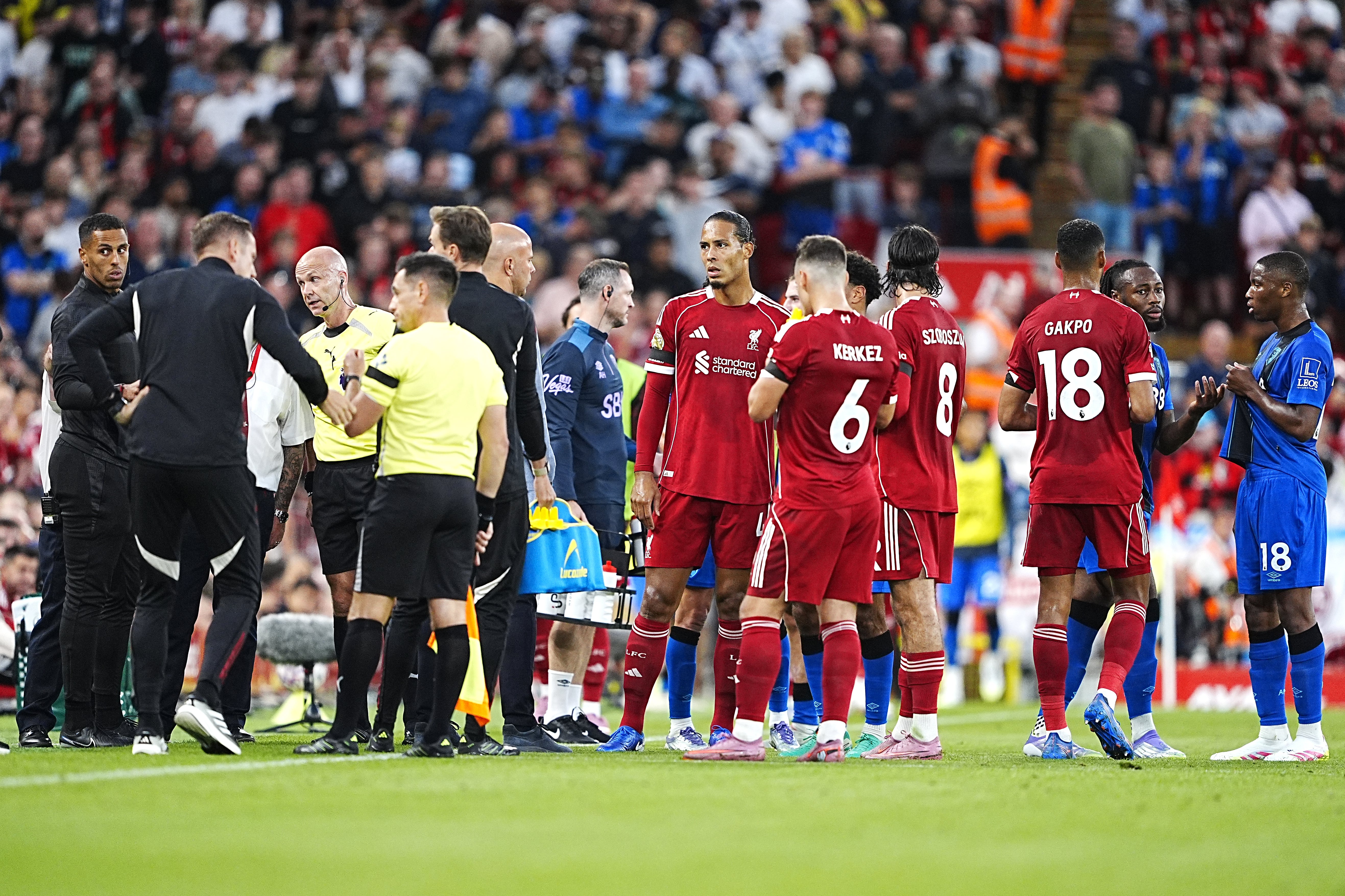 The players during a stop in play after Antoine Semenyo, second right, informed the referee Anthony Taylor (third left) of an alleged racial comment from the crowd (Peter Byrne/PA)