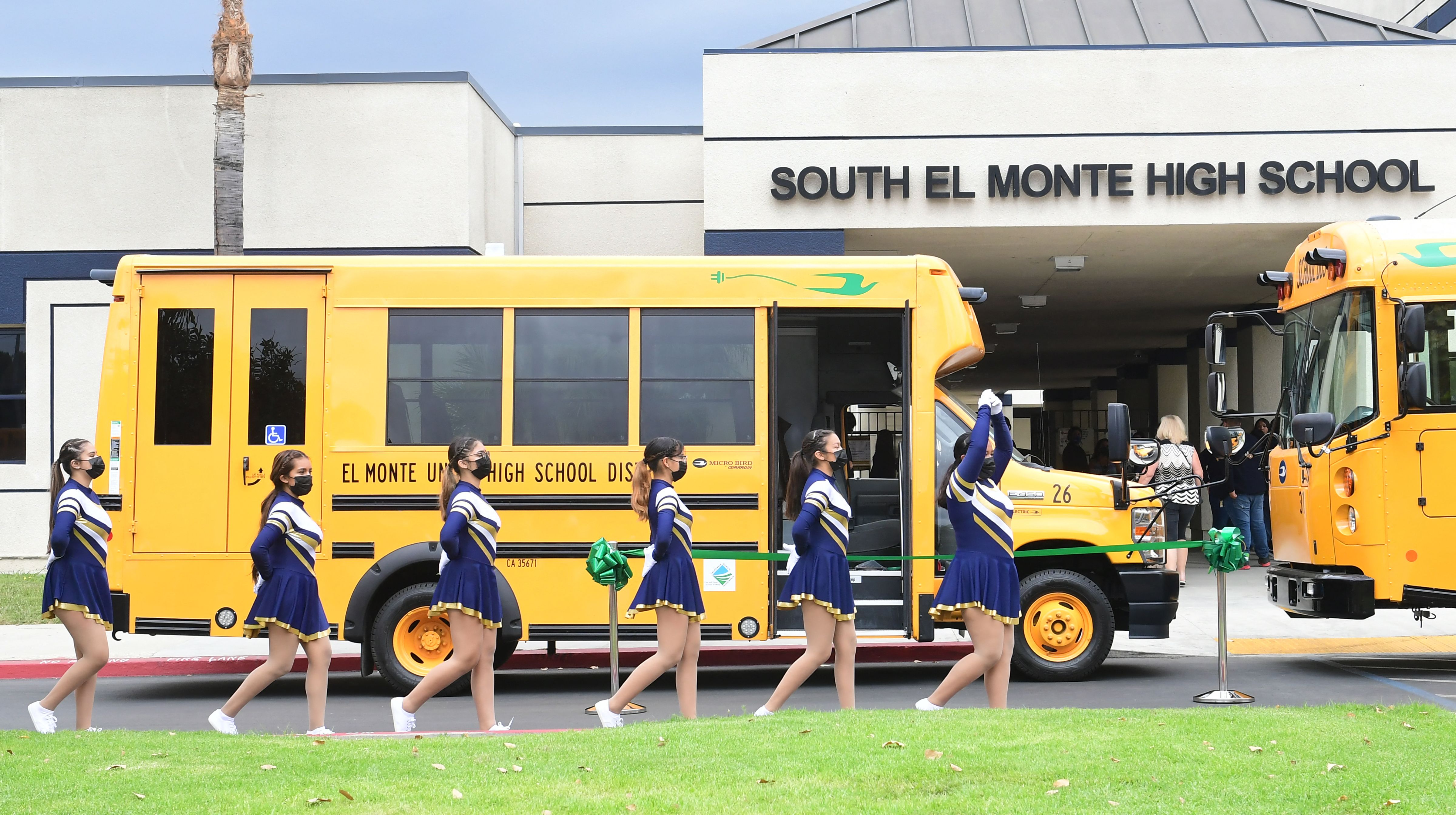 Cheerleaders from South El Monte High School walk past the school buses in August 2021 in El Monte, California. Harvard researchers say more needs to be done to determine how schools reopening during the Covid pandemic affected marginalized students