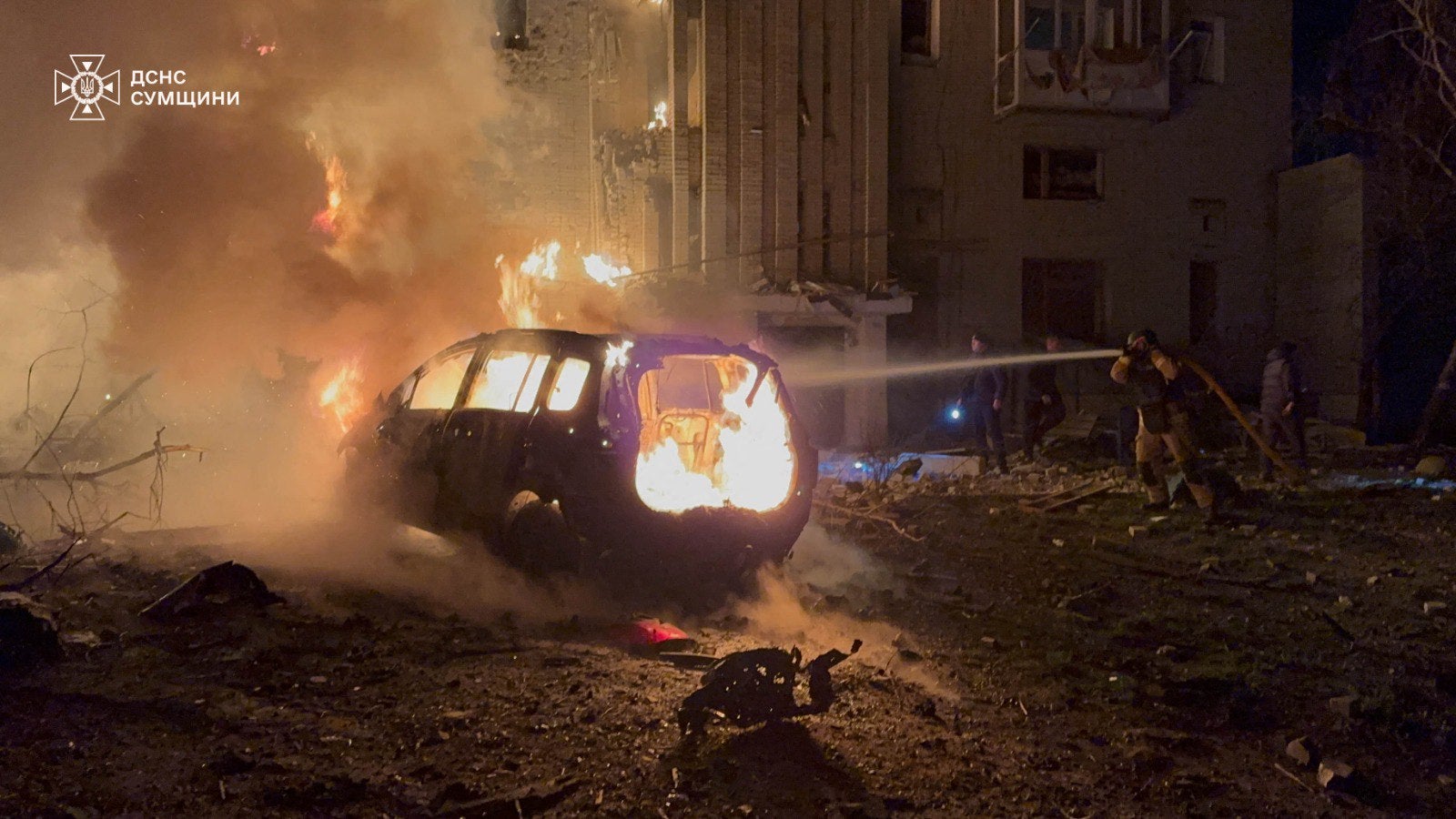 Firefighters working to extinguish a fire following a drone attack on a residential building in Okhtyrka, Sumy region, on 8 December