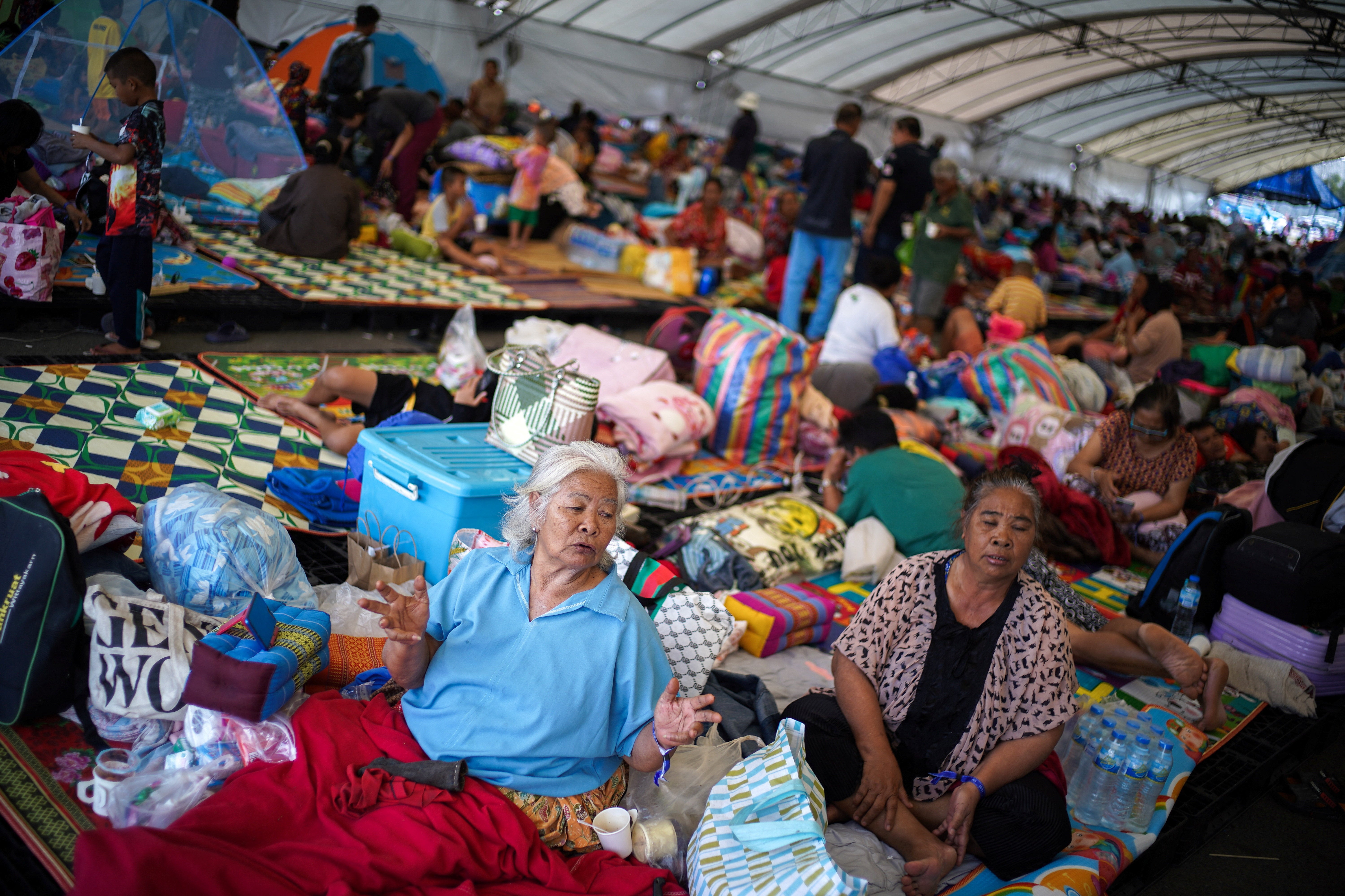 Displaced people gather inside a temporary shelter amid deadly clashes between Thailand and Cambodia along a disputed border area, in Buriram province, Thailand, 9 December 2025