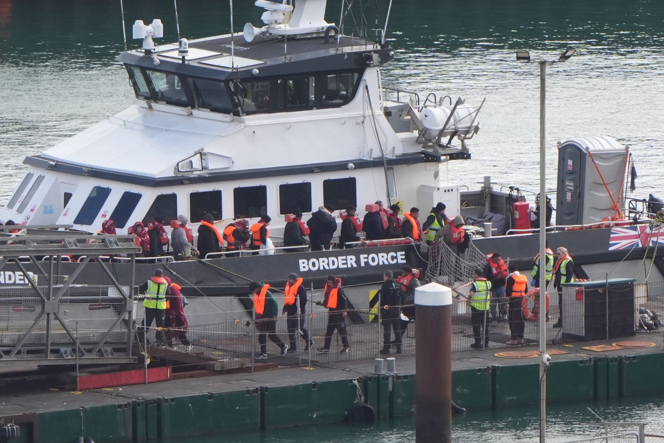 A group of people thought to be migrants are brought in to Dover, Kent, from a Border Force vessel last month (PA)