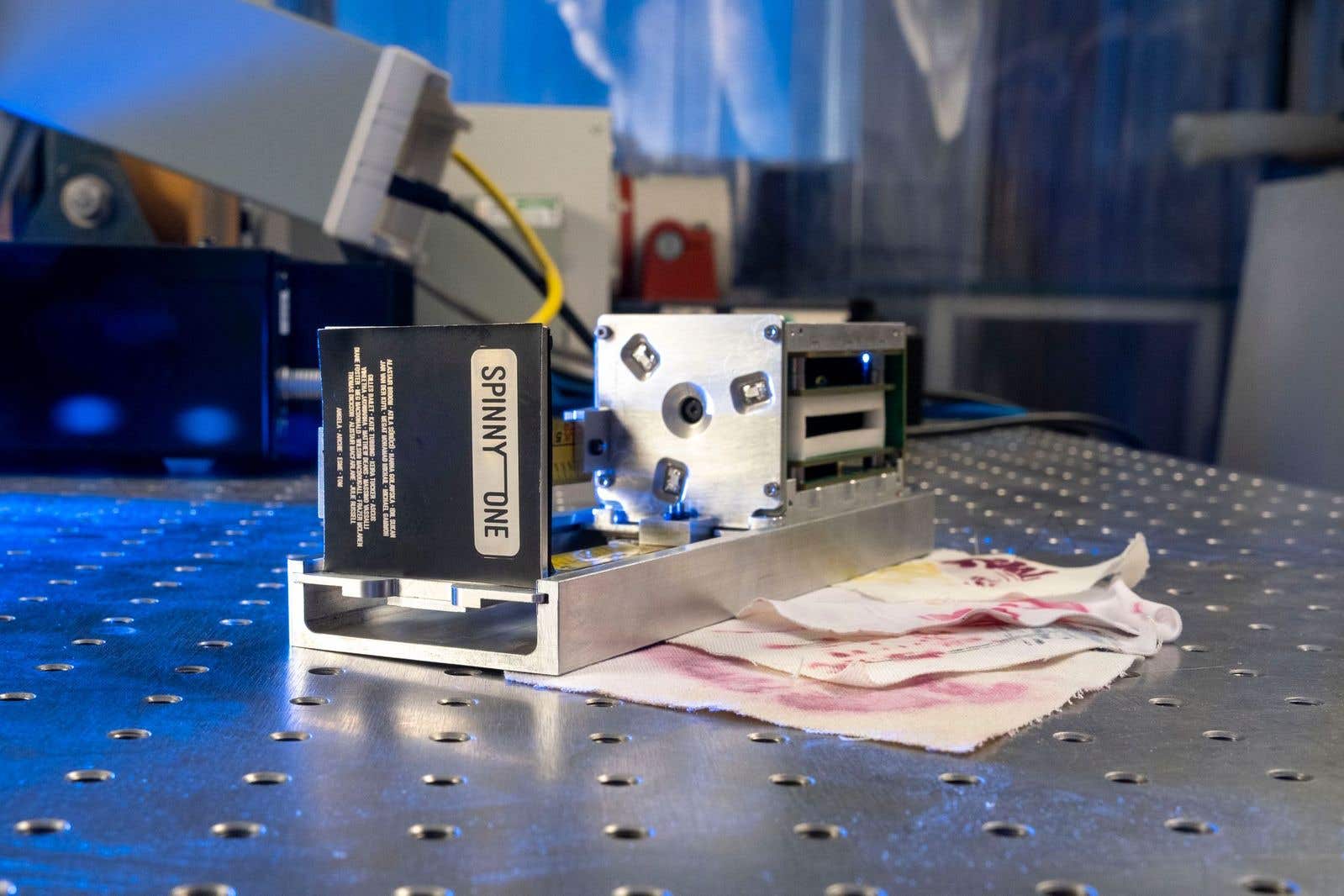A tiny satellite will carry the fabric into space (University of Glasgow/PA)