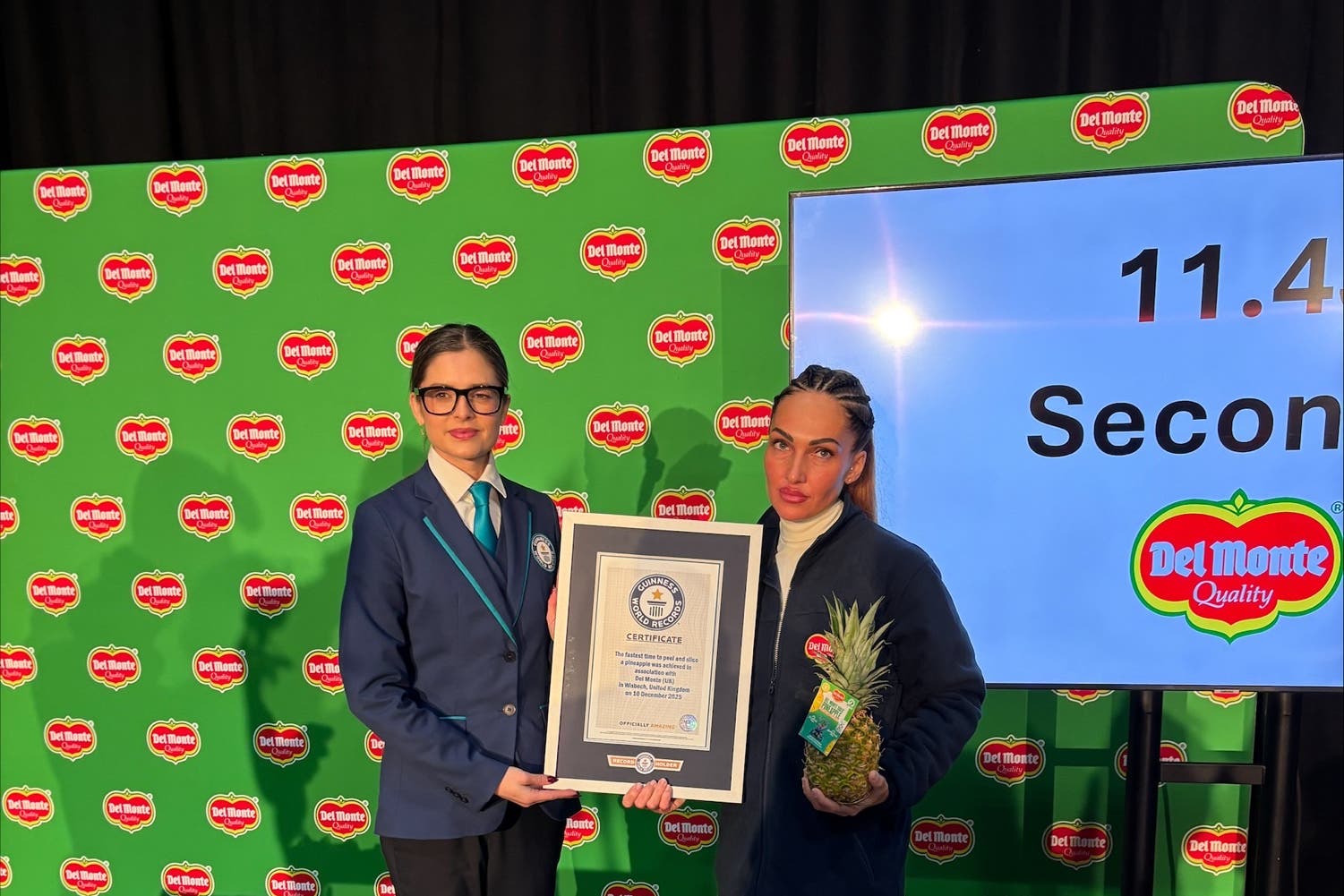 Guinness World Records official adjudicator Joanne Brent with factory worker Dominika Gasparova, who peeled and sliced a pineapple in 11.43 seconds – a world record (Sam Russell/PA)