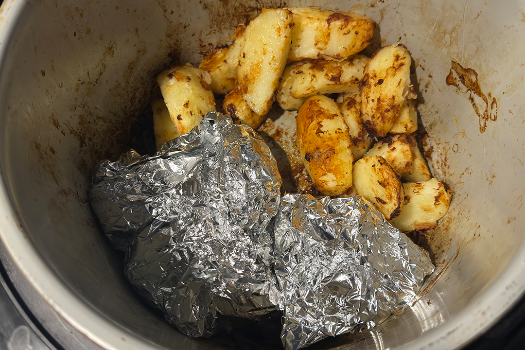 You can wrap carrots in tin foil and add them as the potatoes are finishing cooking
