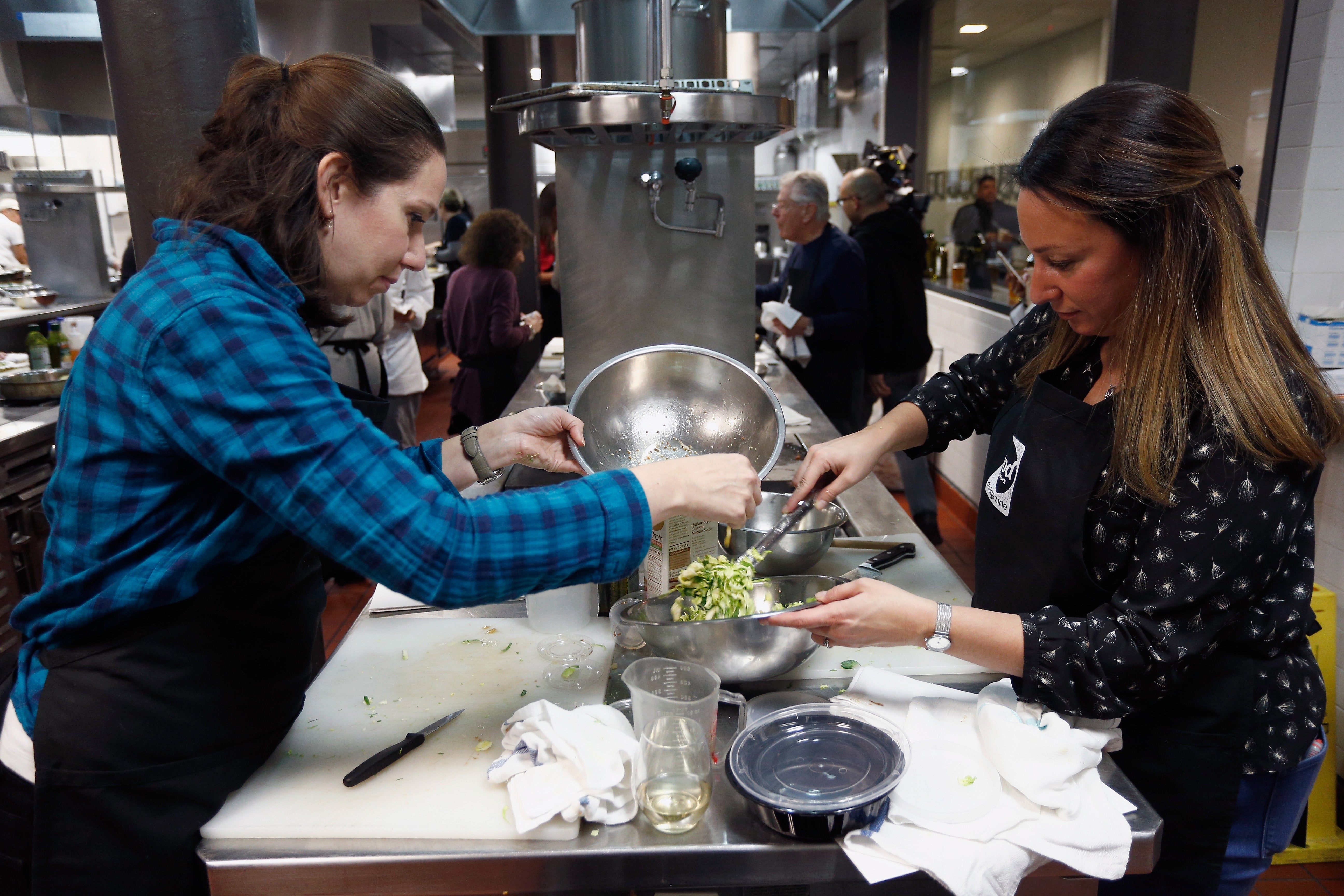 Women prepare Brussels sprouts at a cooking school in New York City in November 2017. The small green vegetable comes packed with a surprising amount of protein and fiber