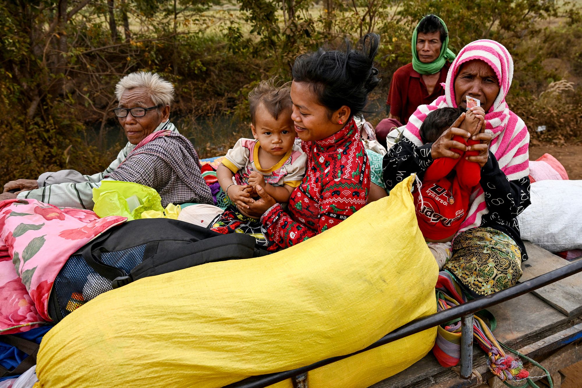 Displaced residents evacuate with their belongings in their vehicle during clashes along the Cambodia-Thailand border in Cambodia's Oddar Meanchey province on December 10, 2025. Half a million evacuees in Cambodia and Thailand were sheltering in pagodas, schools and other safe havens on December 10, 2025 after fleeing renewed fighting in a century-old border dispute in which US President Donald Trump has vowed to again intercede. (Photo by TANG CHHIN Sothy / AFP via Getty Images)