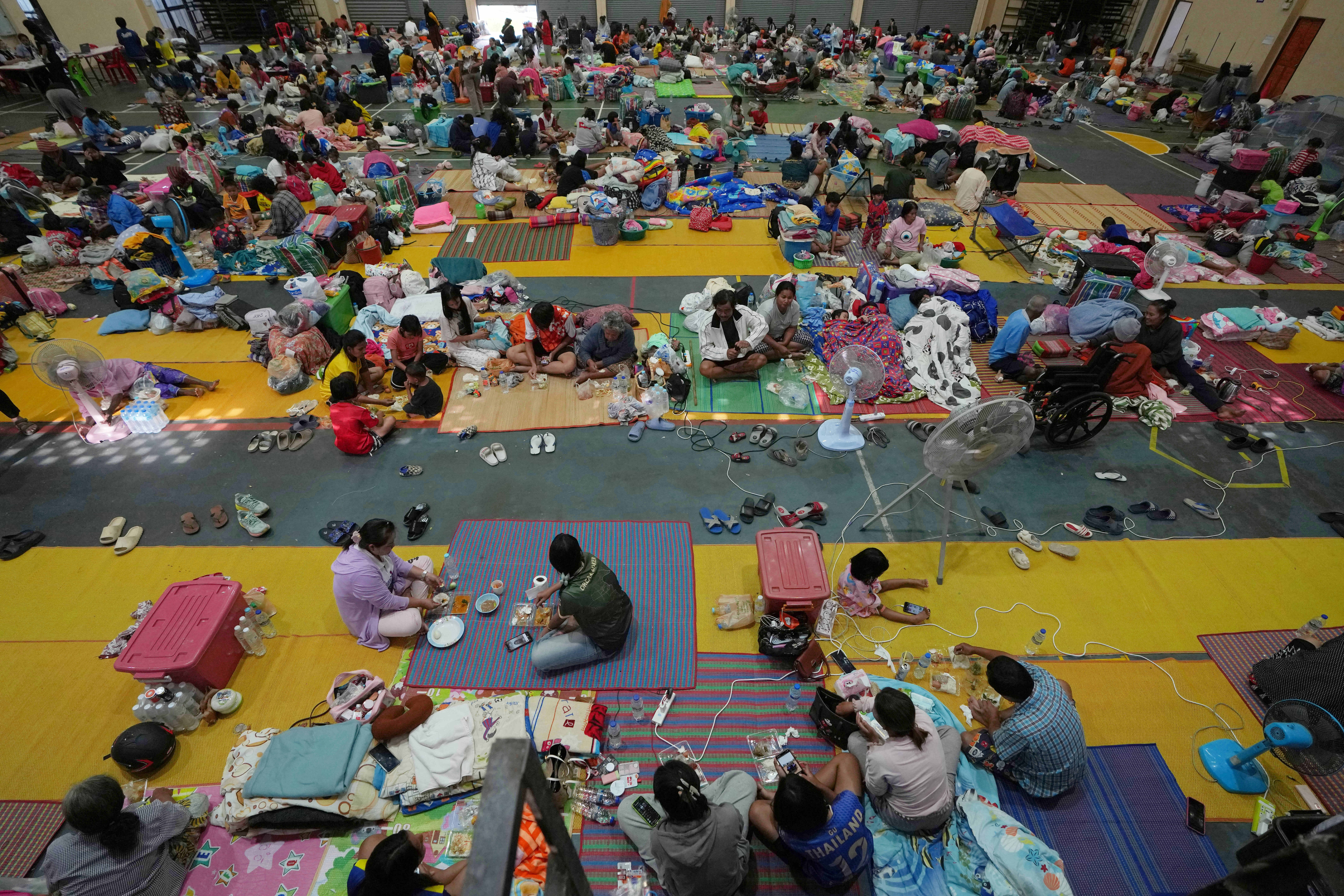 People displaced by fighting between Thai and Cambodian soldiers rest at an evacuation centre in Surin province of Thailand