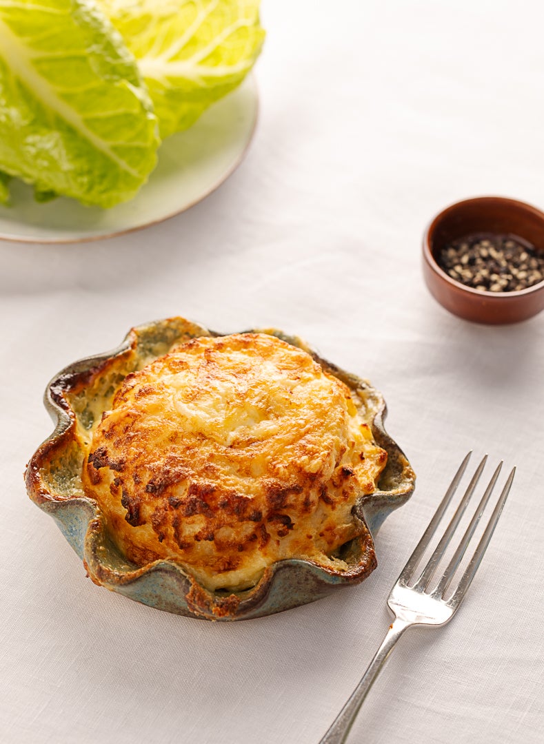 The twice-baked cheddar souffle that regulars travel for – proof that classic cooking, done well, never goes out of fashion
