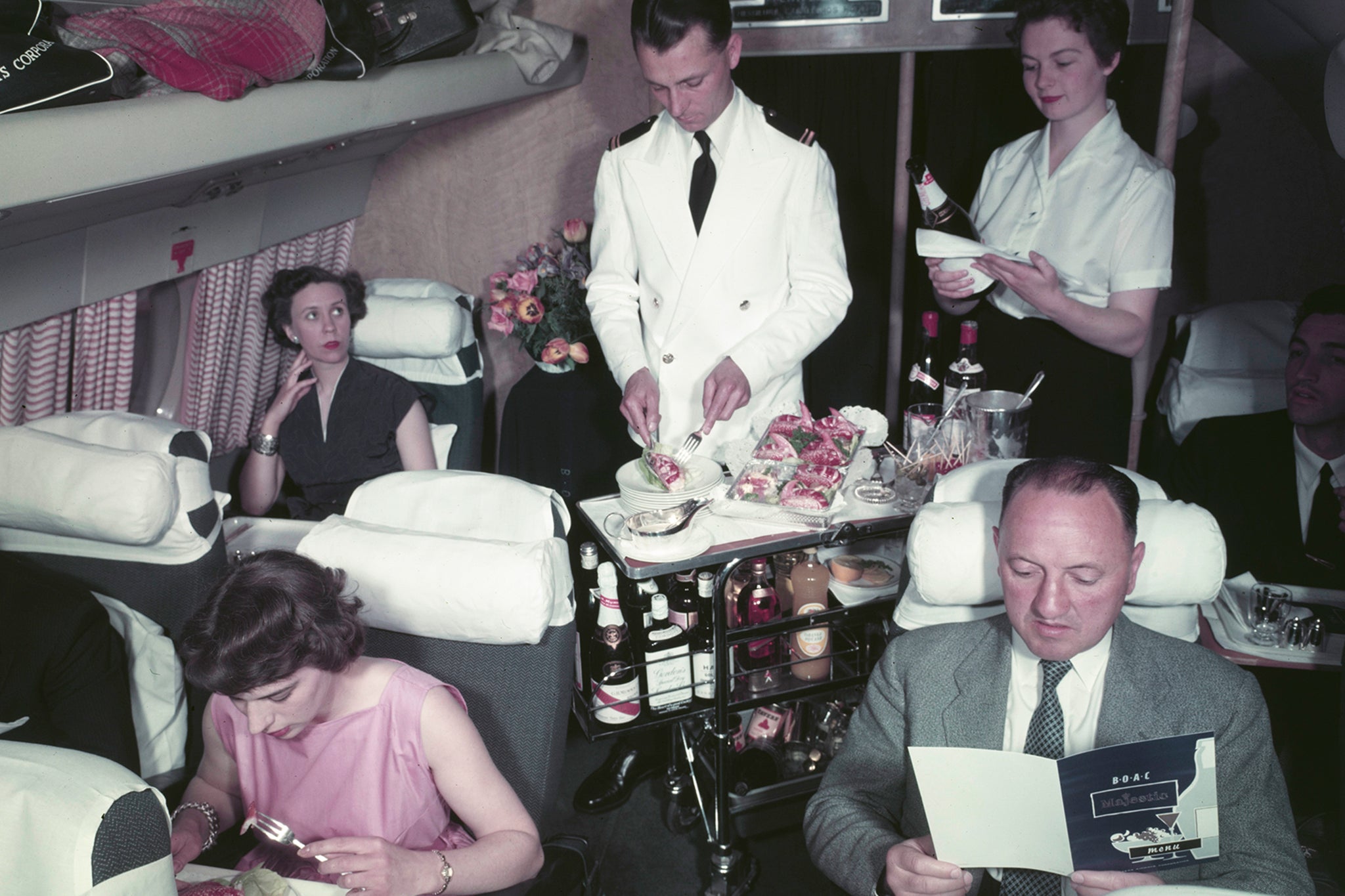 Golden age: Passengers being served food and drink from a trolley by a steward in a Bristol Britannia airliner in 1956