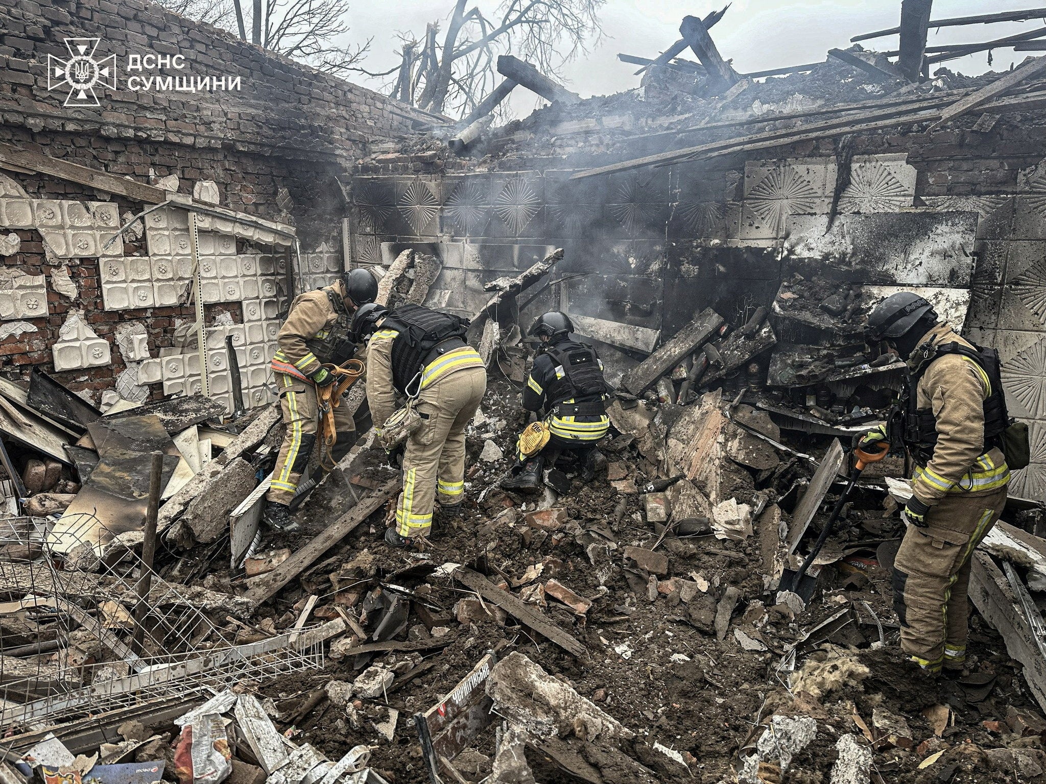 <p>Rescuers work at the site where a store was hit by a Russian airstrike in the Sumy region, Ukraine</p>