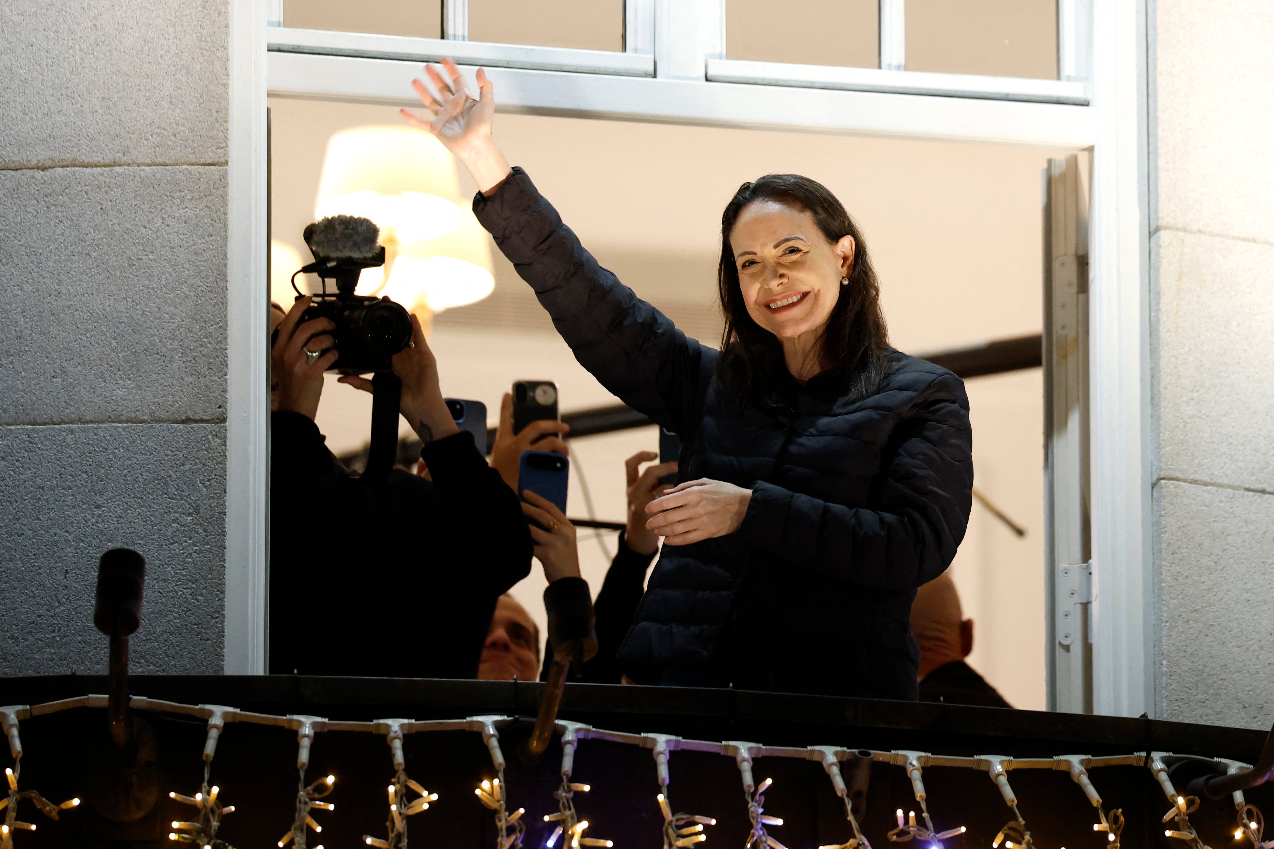 Nobel peace laureate Maria Corina Machado greets supporters from a balcony of the Grand Hotel in Oslo, Norway