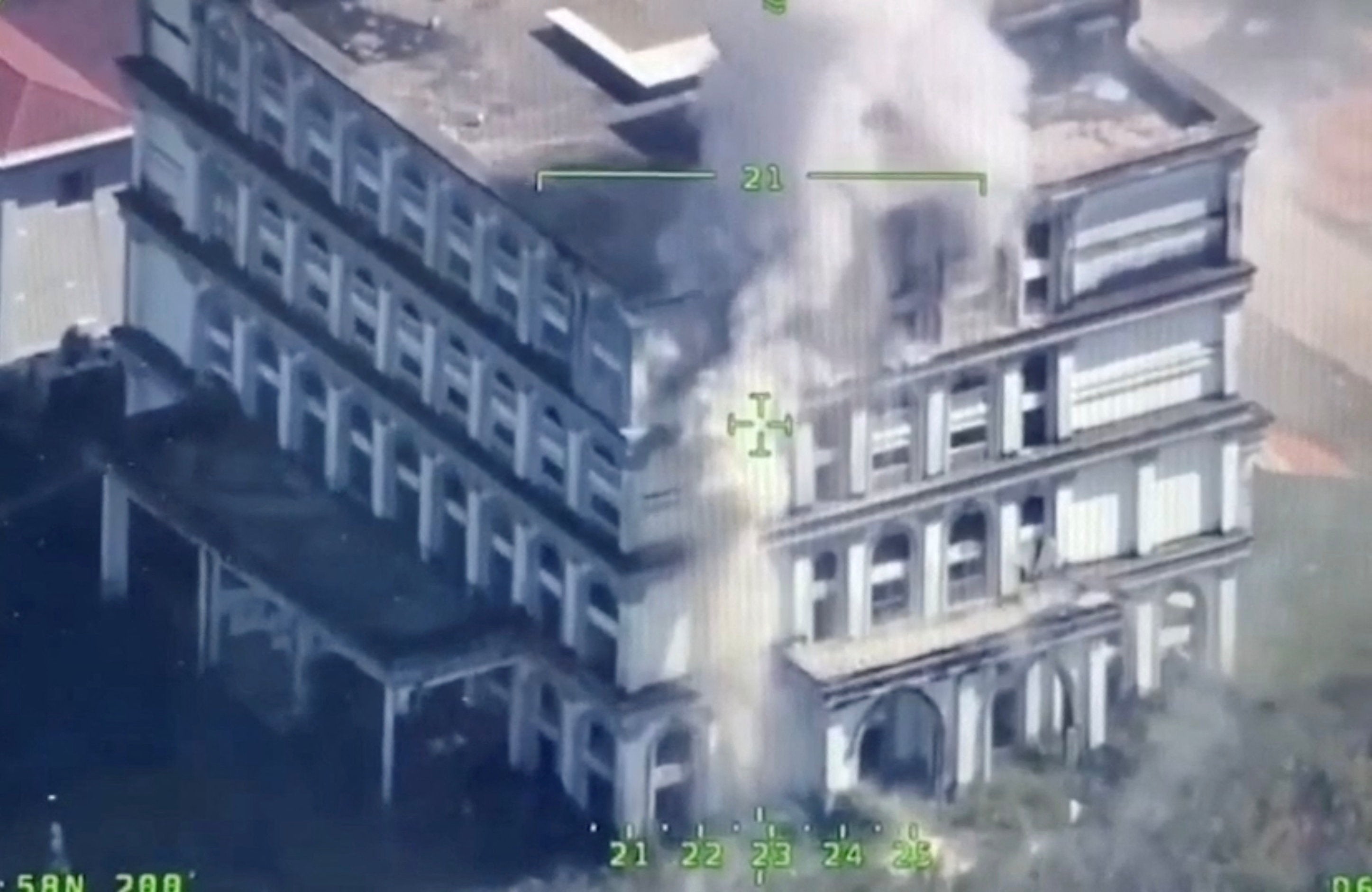 A drone view shows smoke rising from a building near the Trat and Thmar Dar border between Thailand and Cambodia