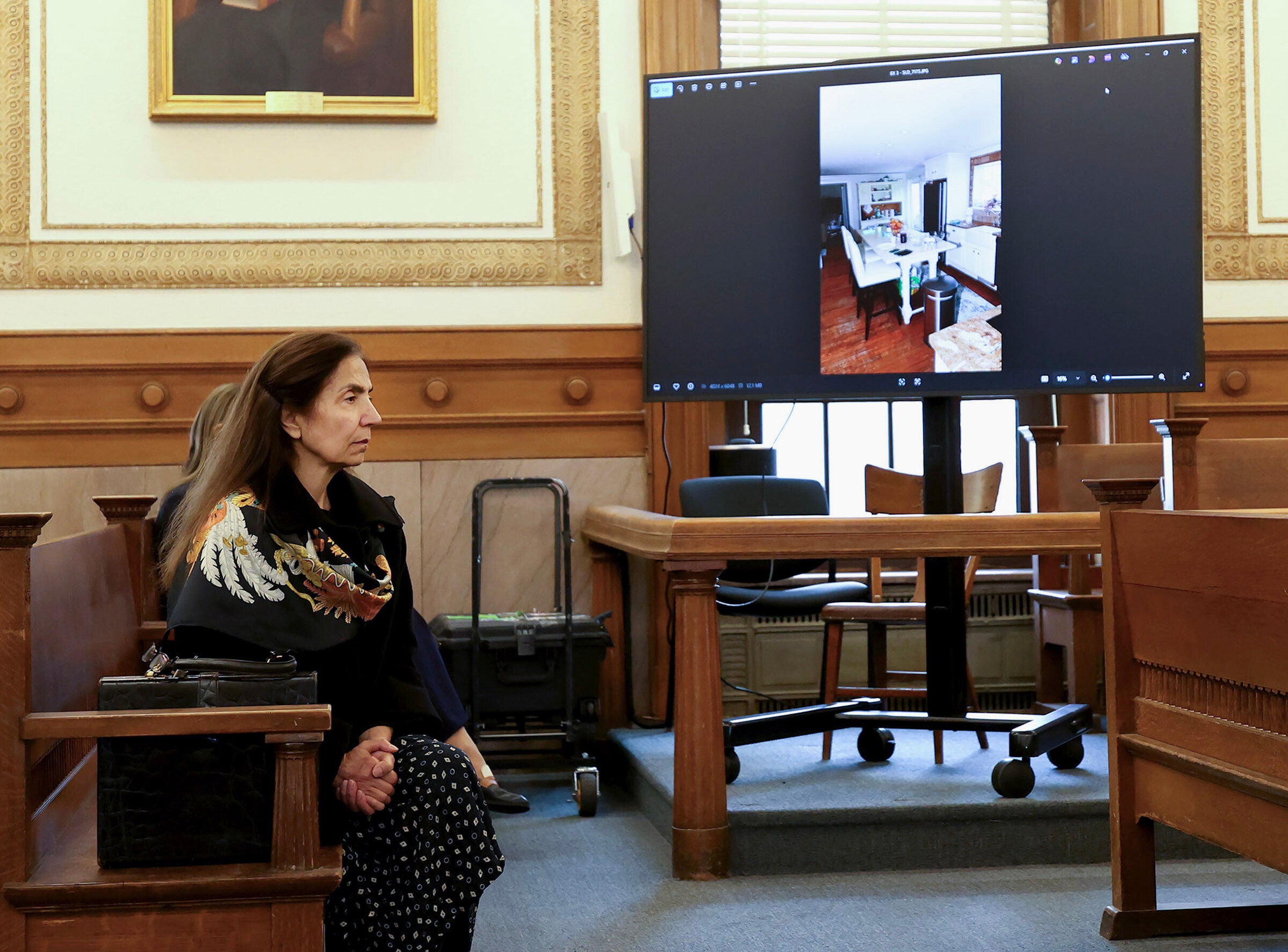 Diana Walshe listens to testimony as a photo of Brian Walshe's kitchen is projected on a monitor during his murder trial, Wednesday, Dec. 10, 2025, in Dedham, Mass. (Mark Stockwell/The Boston Herald via AP, Pool)