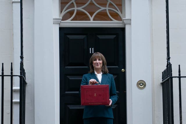 Chancellor of the Exchequer Rachel Reeves poses outside 11 Downing Street, London, with her ministerial red box before delivering her Budget in the House of Commons (Stefan Rousseau/PA)