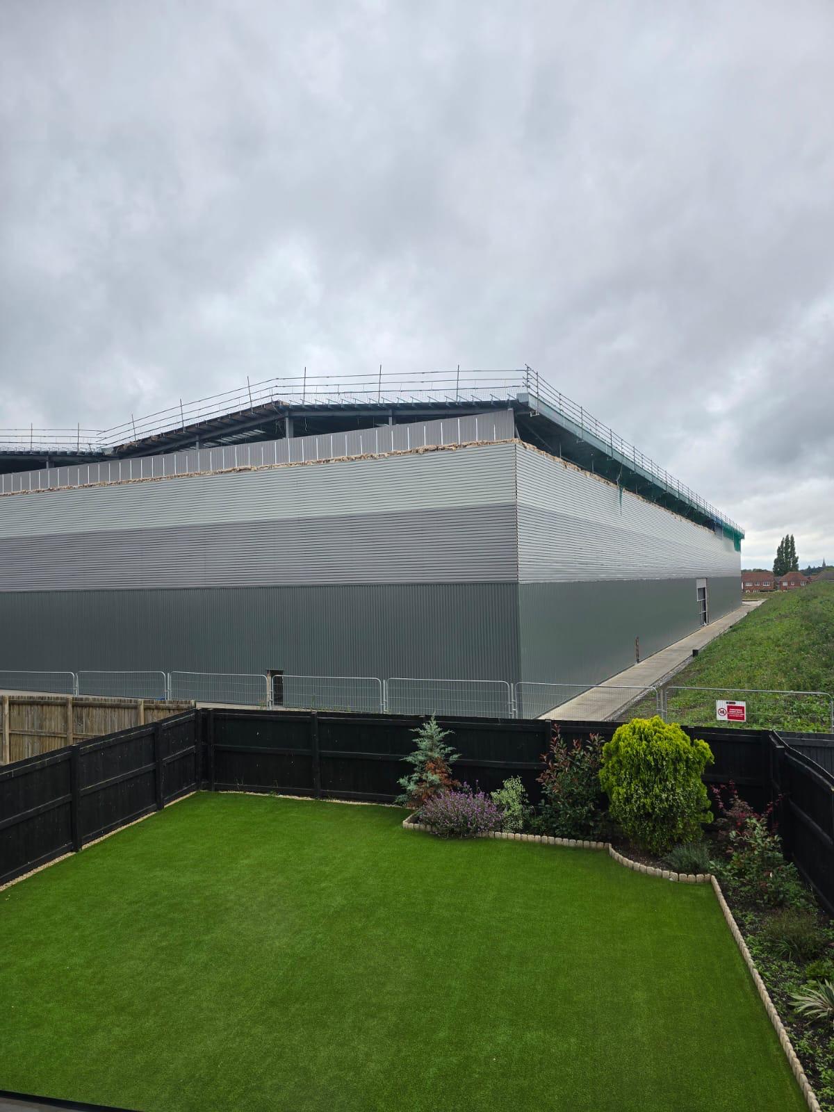 The view of one of the warehouses from a resident’s garden