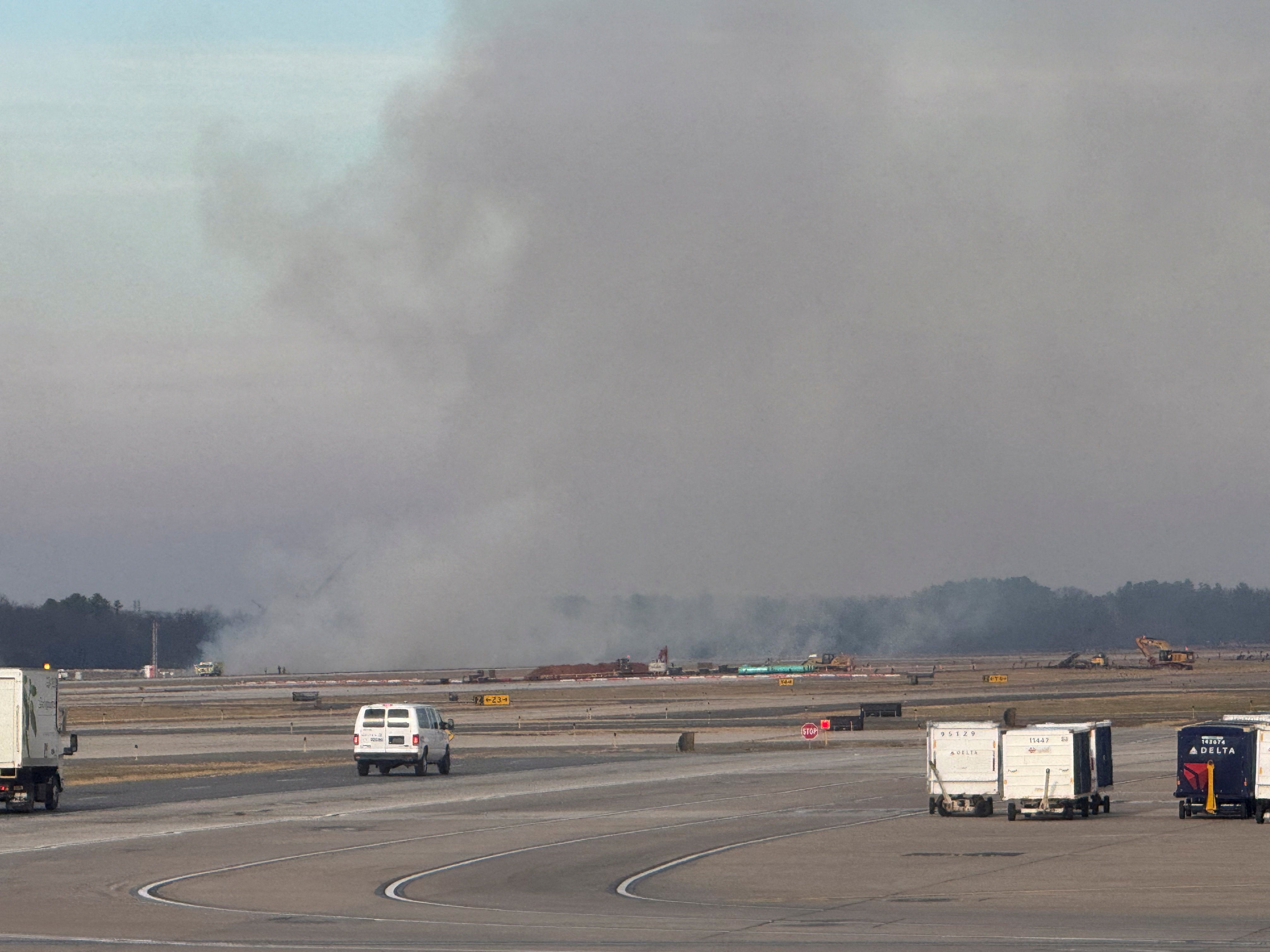 Smoke rising from a small brush fire that was ignited when a United Airlines flight lost engine power