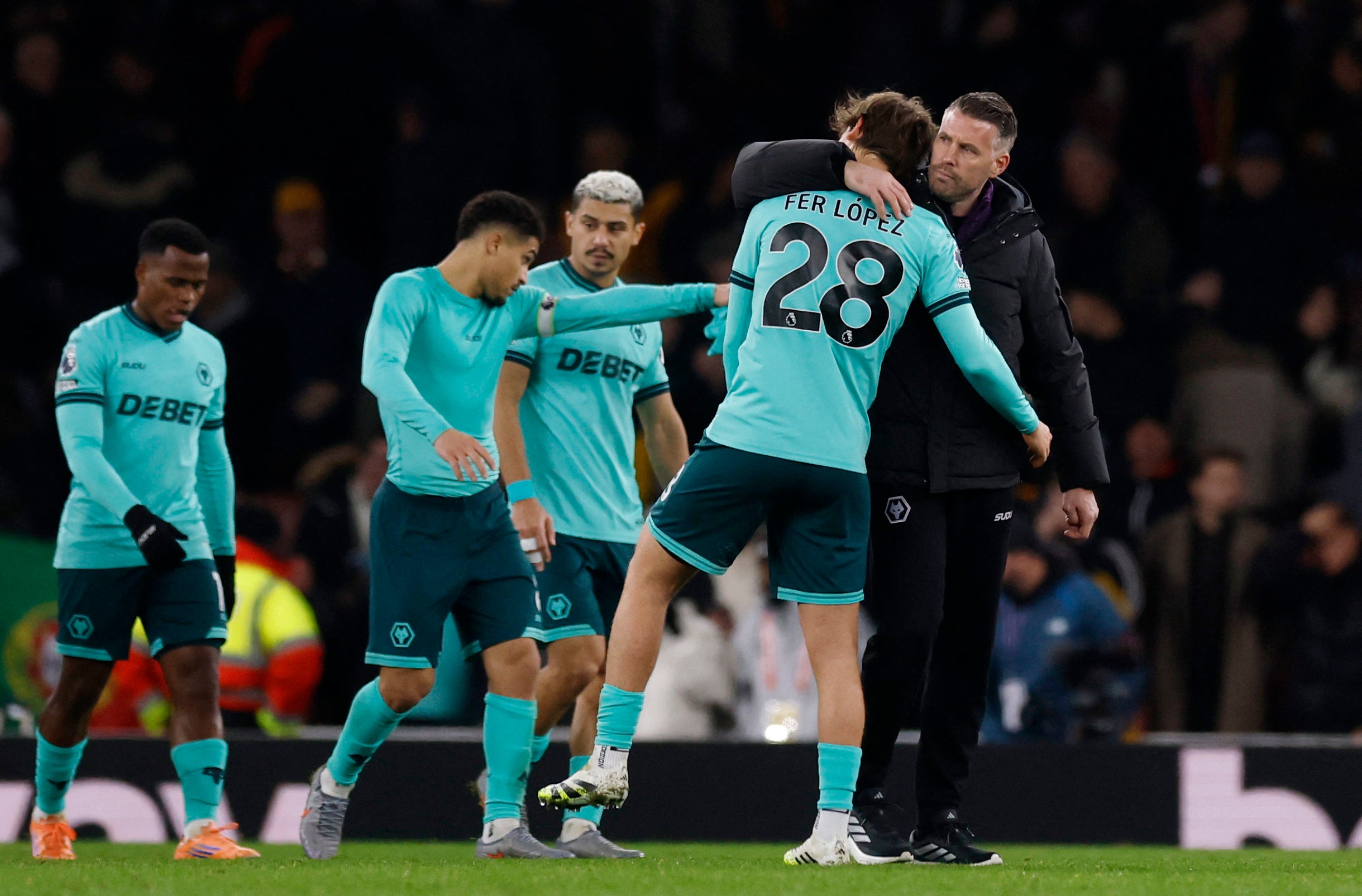 Wolves head coach Rob Edwards consoles a player
