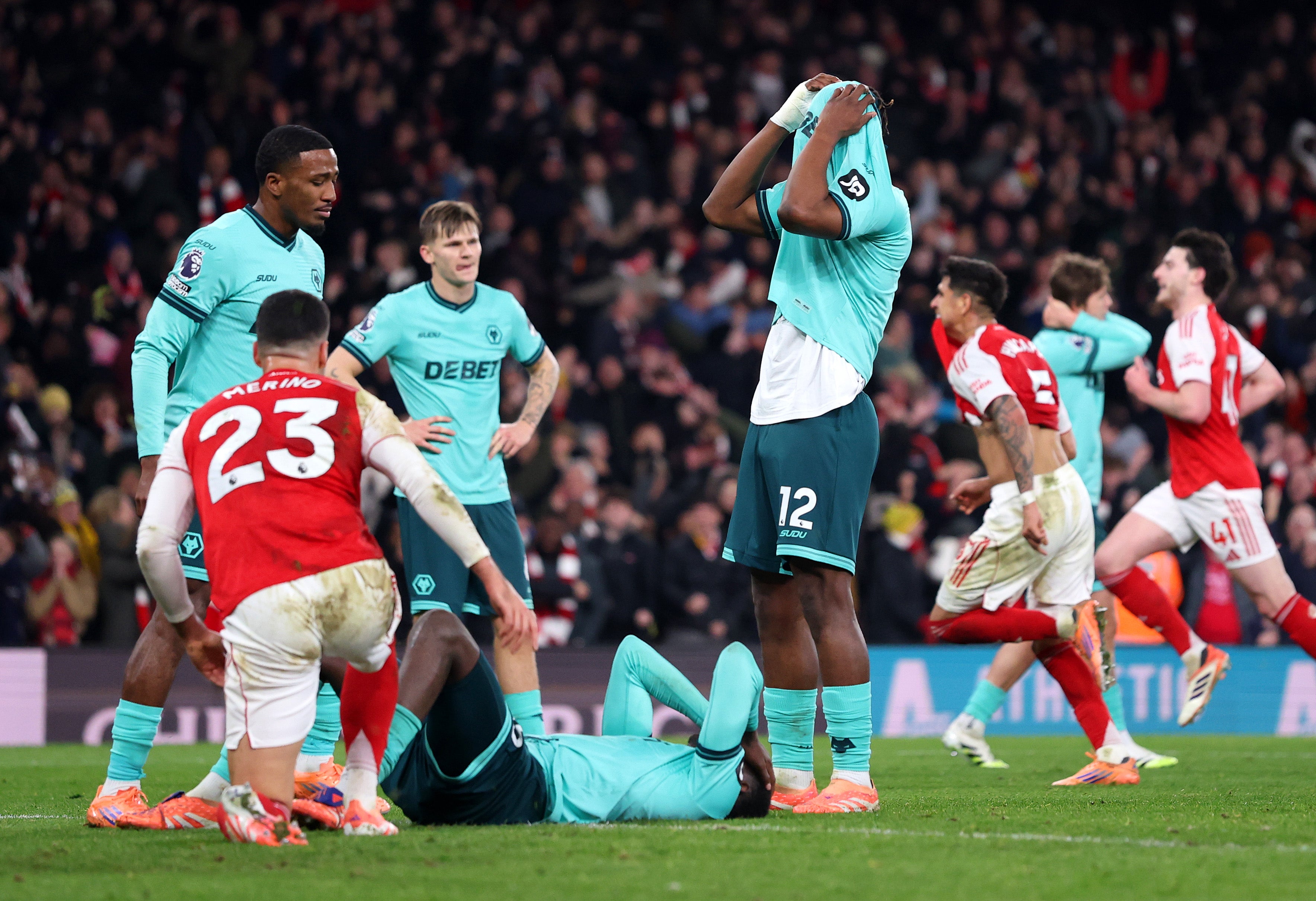 <p>Wolves players react after falling to a last-gasp defeat at Arsenal  after Yerson Mosquera’s own goal </p>