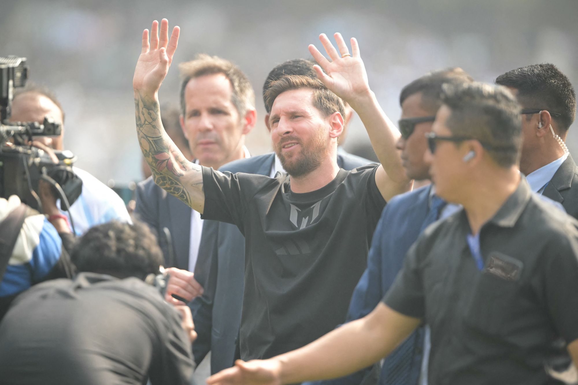 <p>Messi was surrounded by a delegation on his brief visit to the stadium</p>