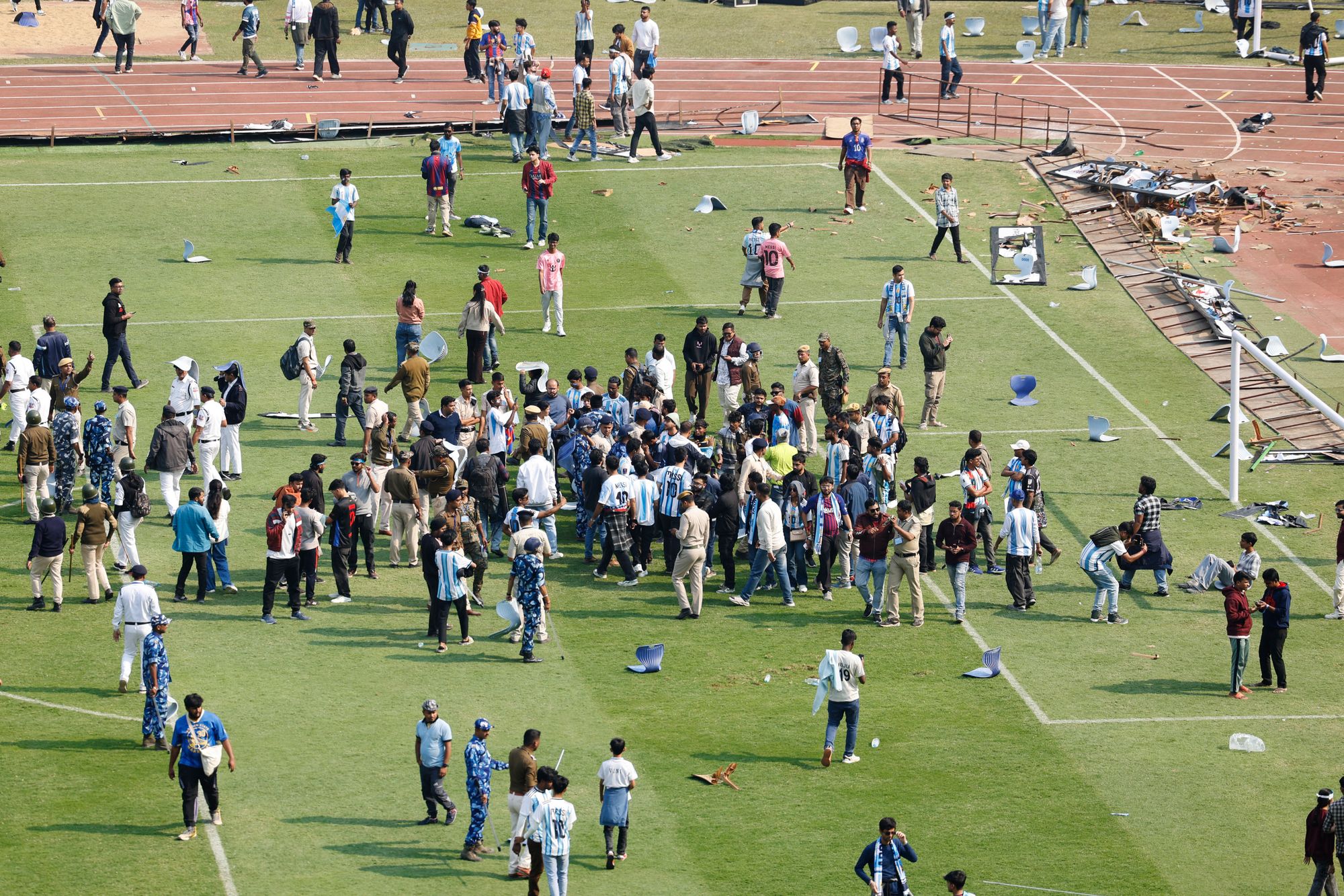 Riot police were called as fans trampled onto the pitch in protest