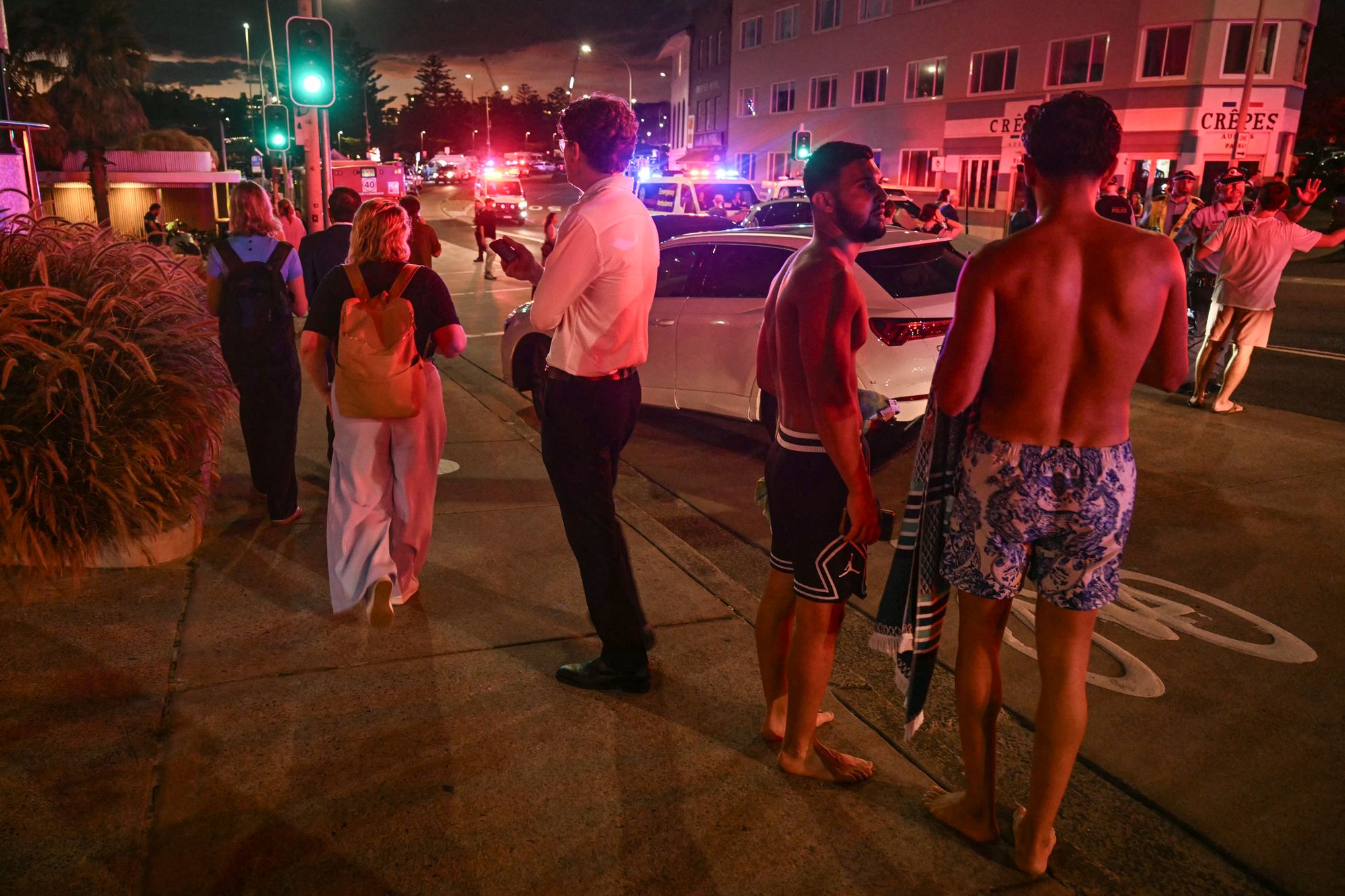 People stand on a street in Sydney after the attack
