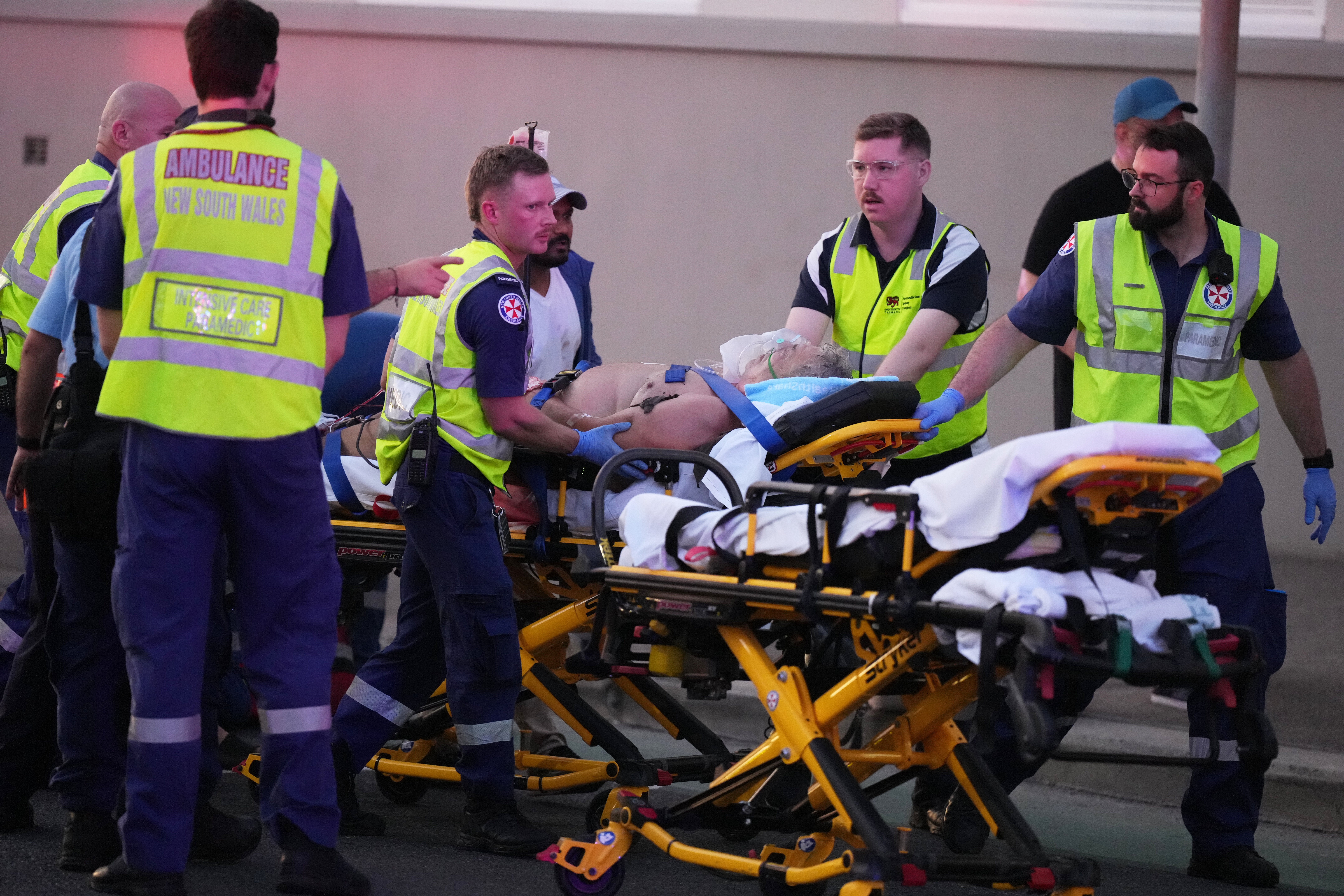 Emergency workers transport a person on a stretcher after the attack on Bondi Beach