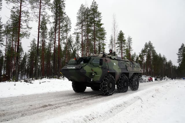 <p>Members of the Finnish army and British Army in an armoured vehicle during a major Nato training exercise on the border with Russia</p>