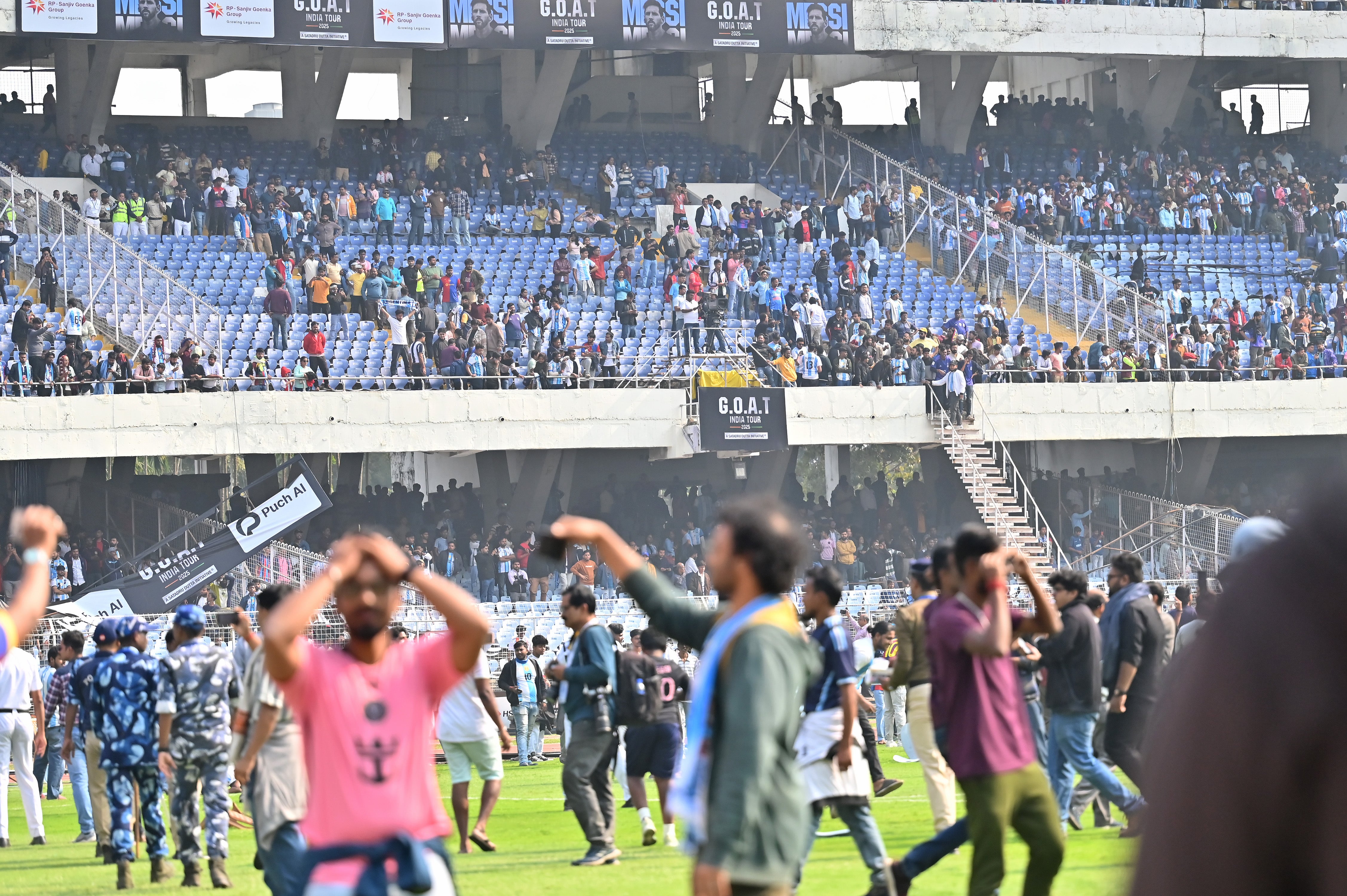 <p>Fans break signage and storm on to the field at Vivekananda Yuva Bharati Krirangan (VYBK) during the Lionel Messi G.O.A.T Tour in Kolkata</p>
