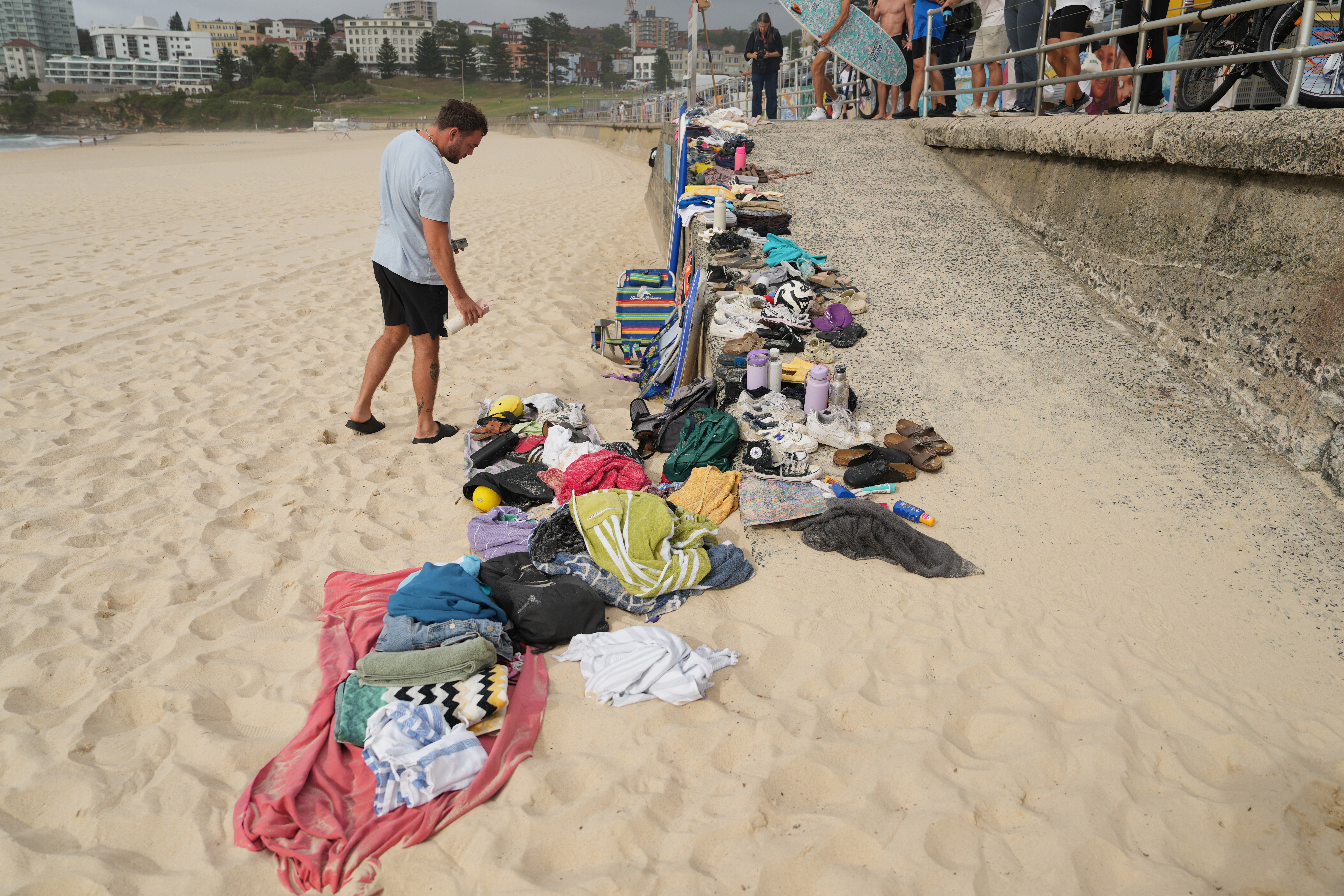 A man looks at belongings stacked up following a shooting the day prior at Sydney's Bondi Beach, Monday, Dec. 15, 2025