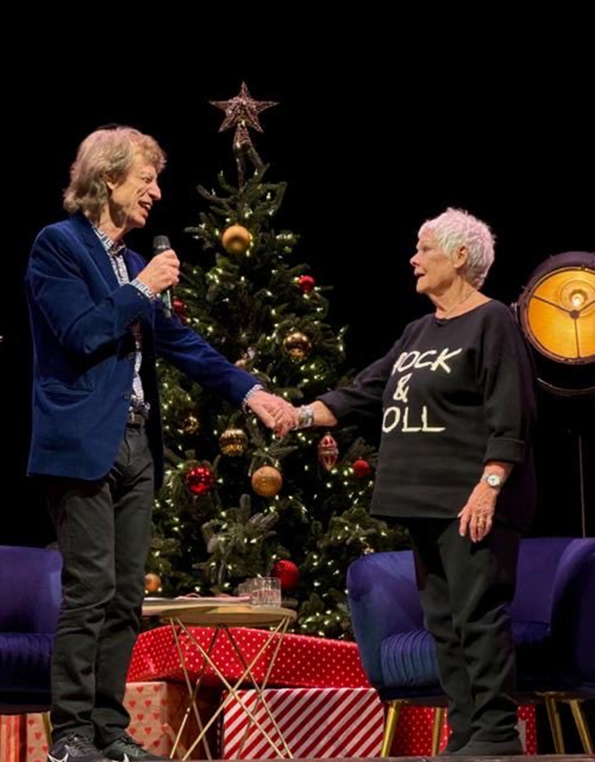 Dame Judi Dench on stage with Mick Jagger at the Sondheim Theatre in London