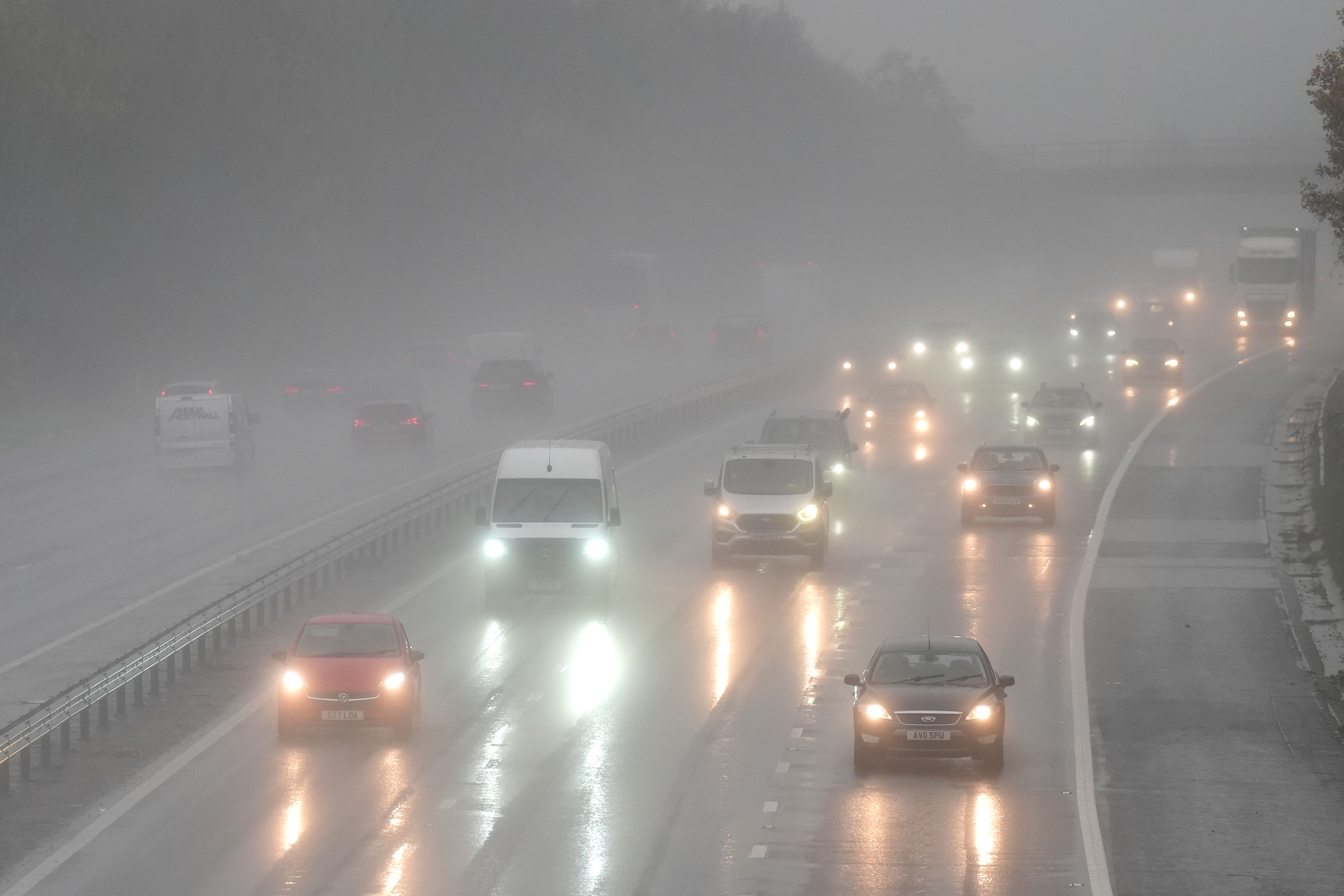 <p>Motorists travel through rain and spray</p>