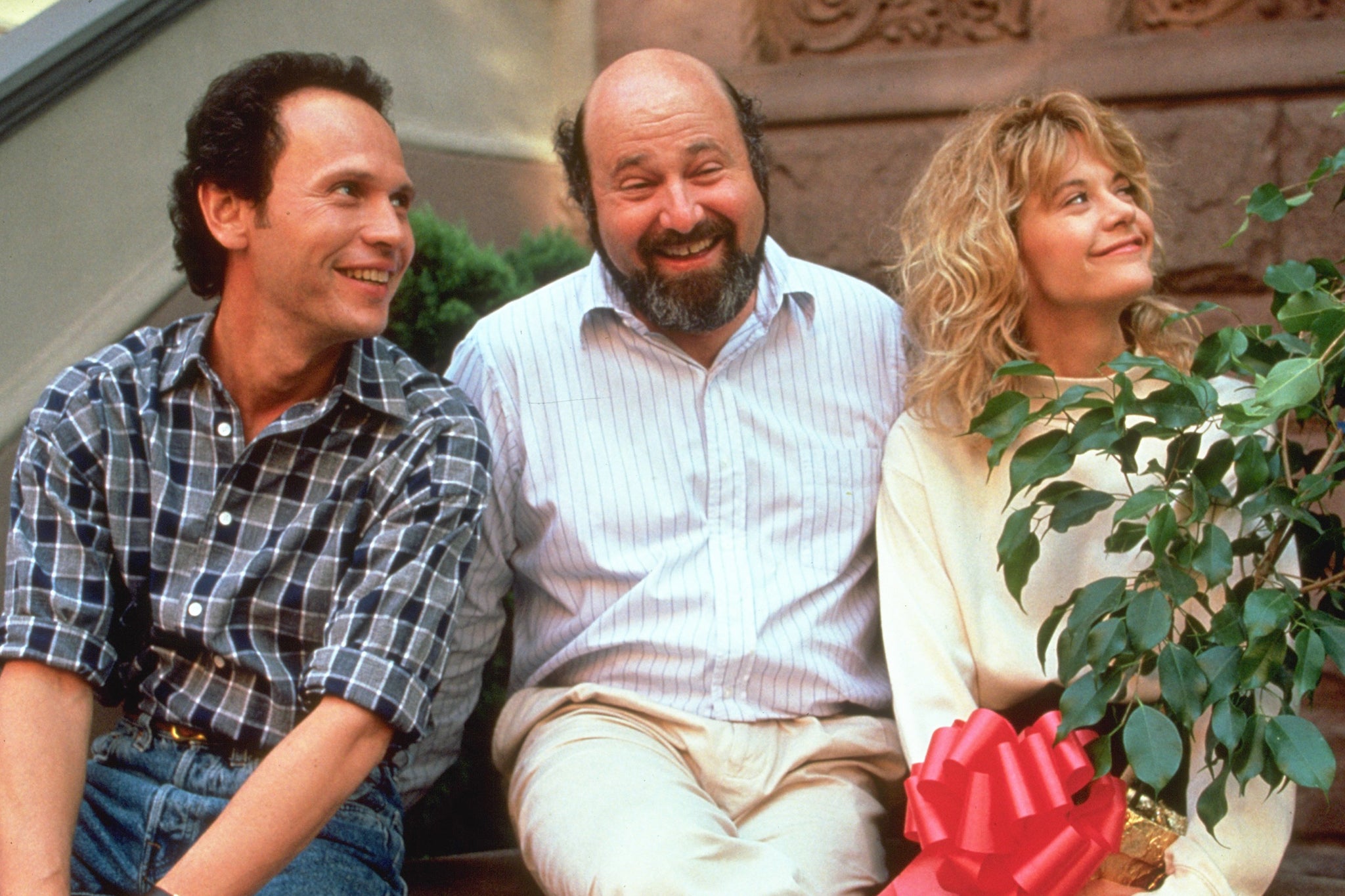 <p>Filmmaker Rob Reiner on the set of ‘When Harry Met Sally’, with his stars Billy Crystal and Meg Ryan</p>