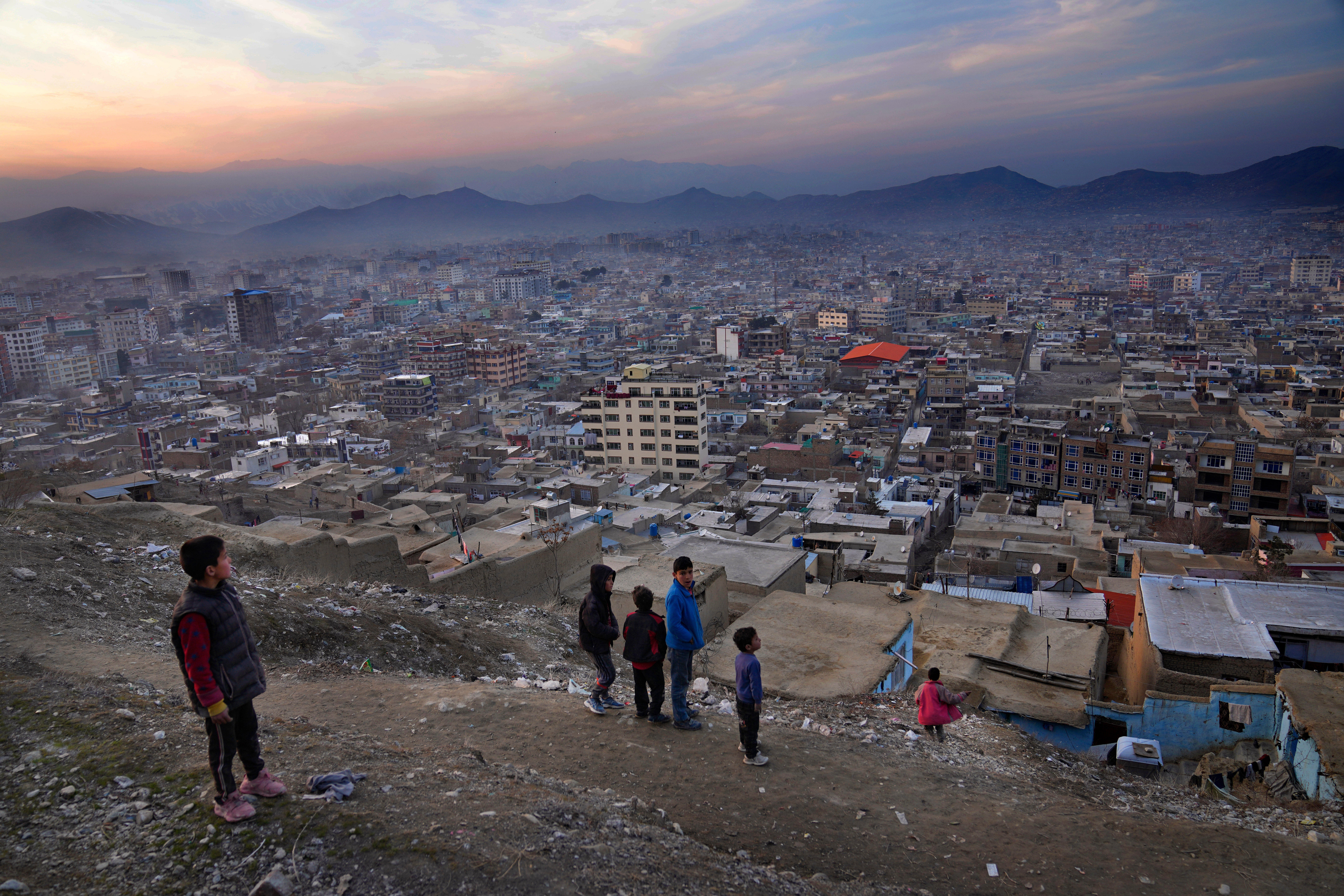 <p>A boy looks over the cityscape of Kabul, the capital of Afghanistan, which is currently grappling with a severe water crisis</p>