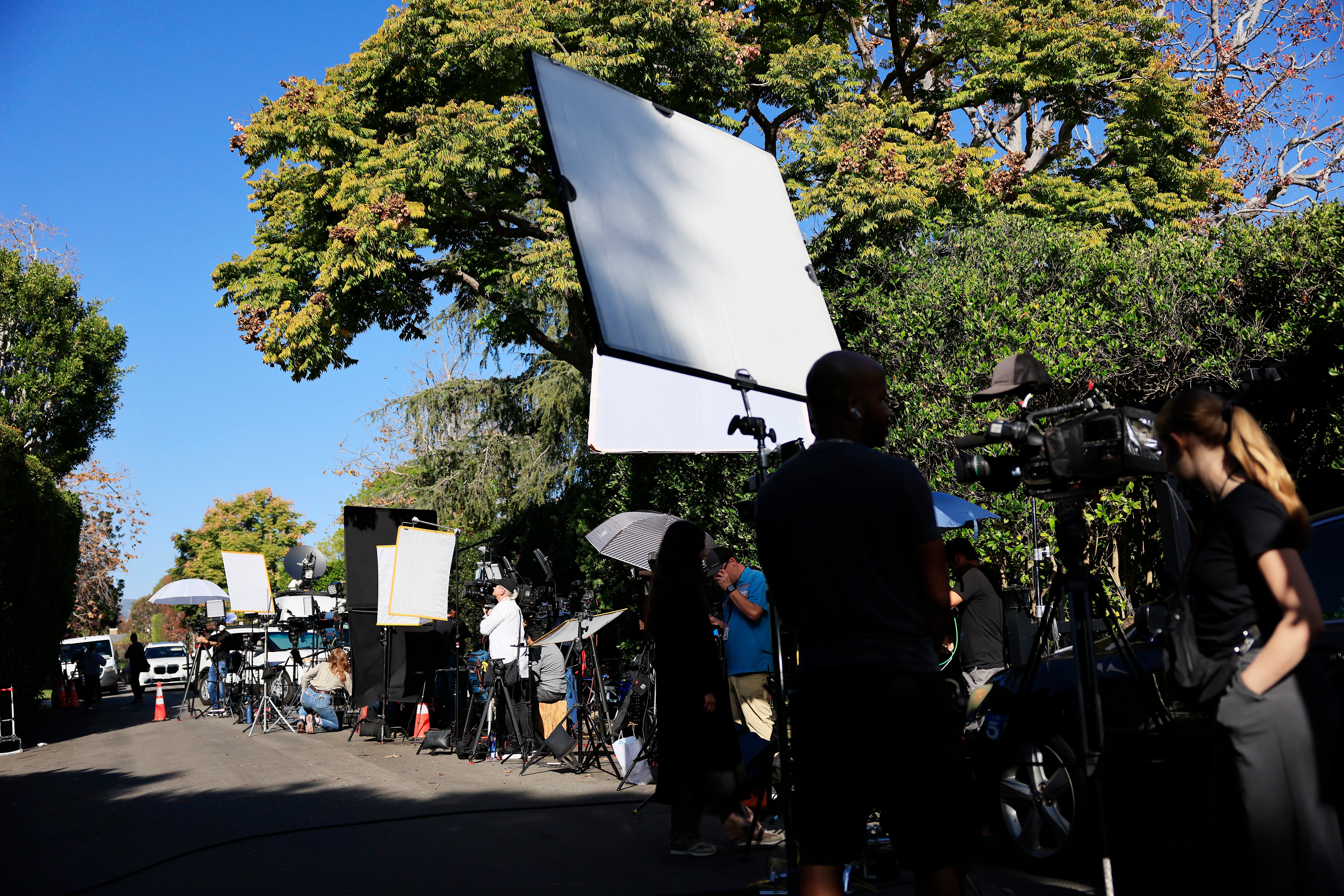 Members of the media outside director Rob Reiner's home on December 15 after he and his wife Michele were found stabbed to death inside their home